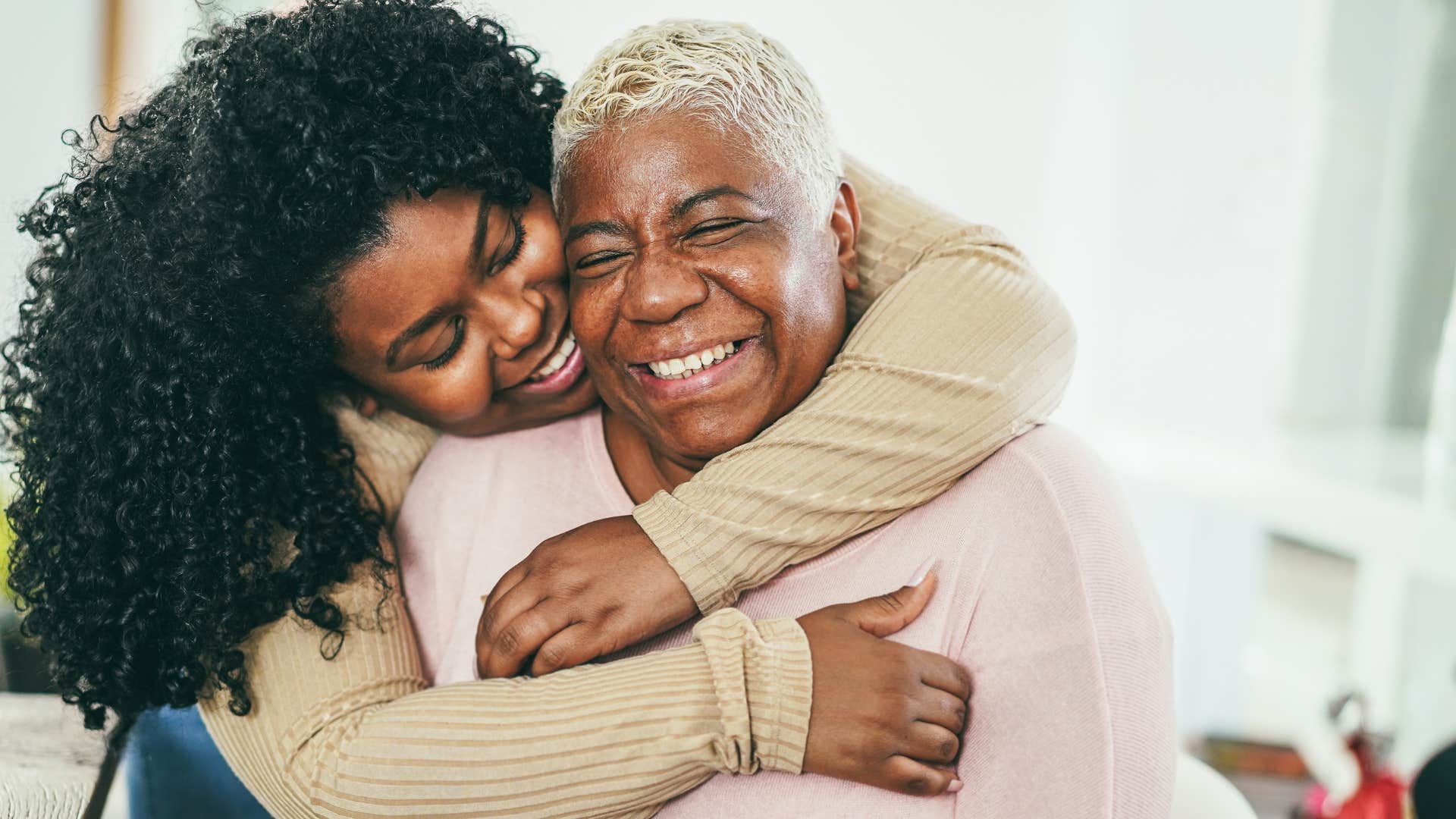 Woman who knows family always comes first hugging her mom.