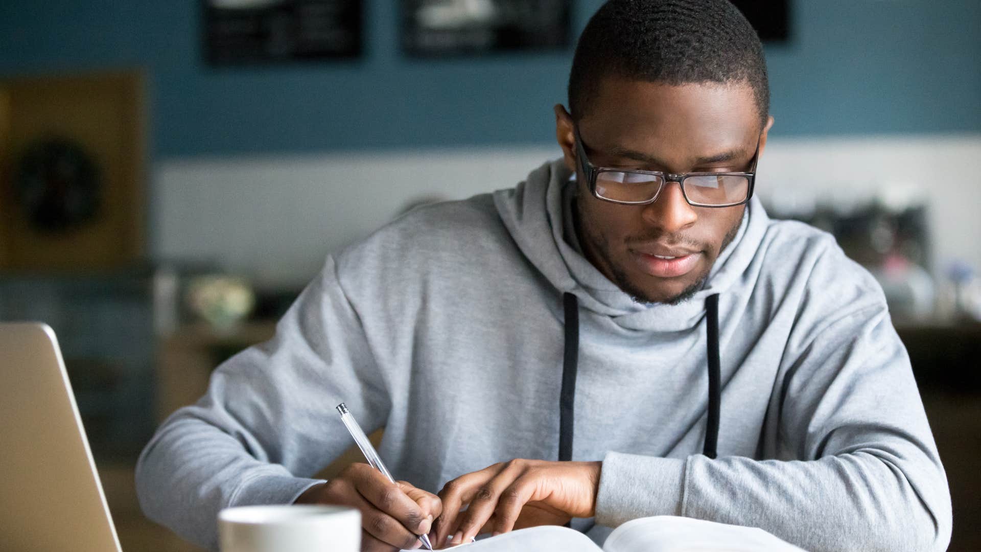 Man who feels pressured to succeed for the family doing homework.