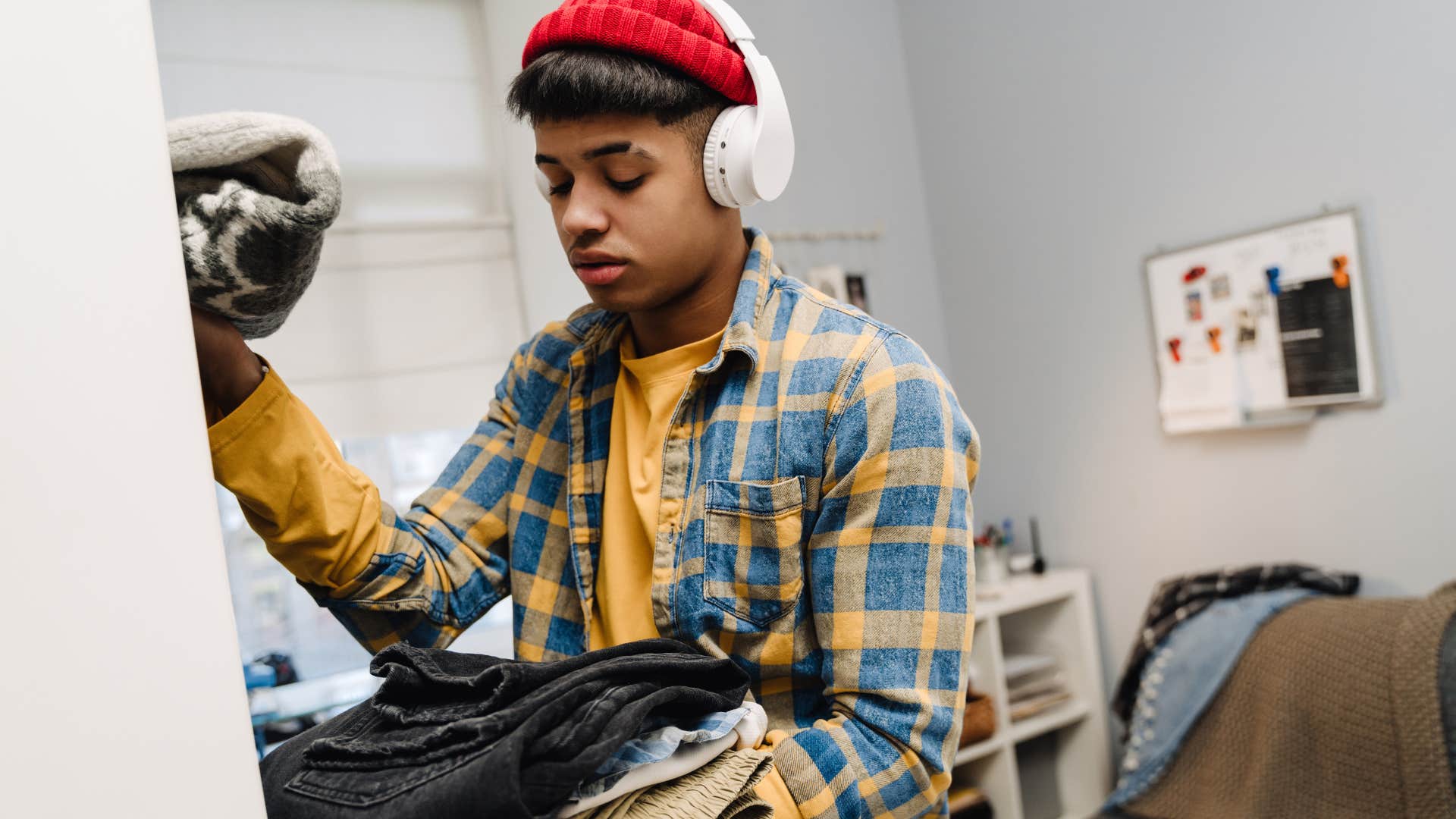 Man who knows that weekends were for chores, not for play, cleaning his room.