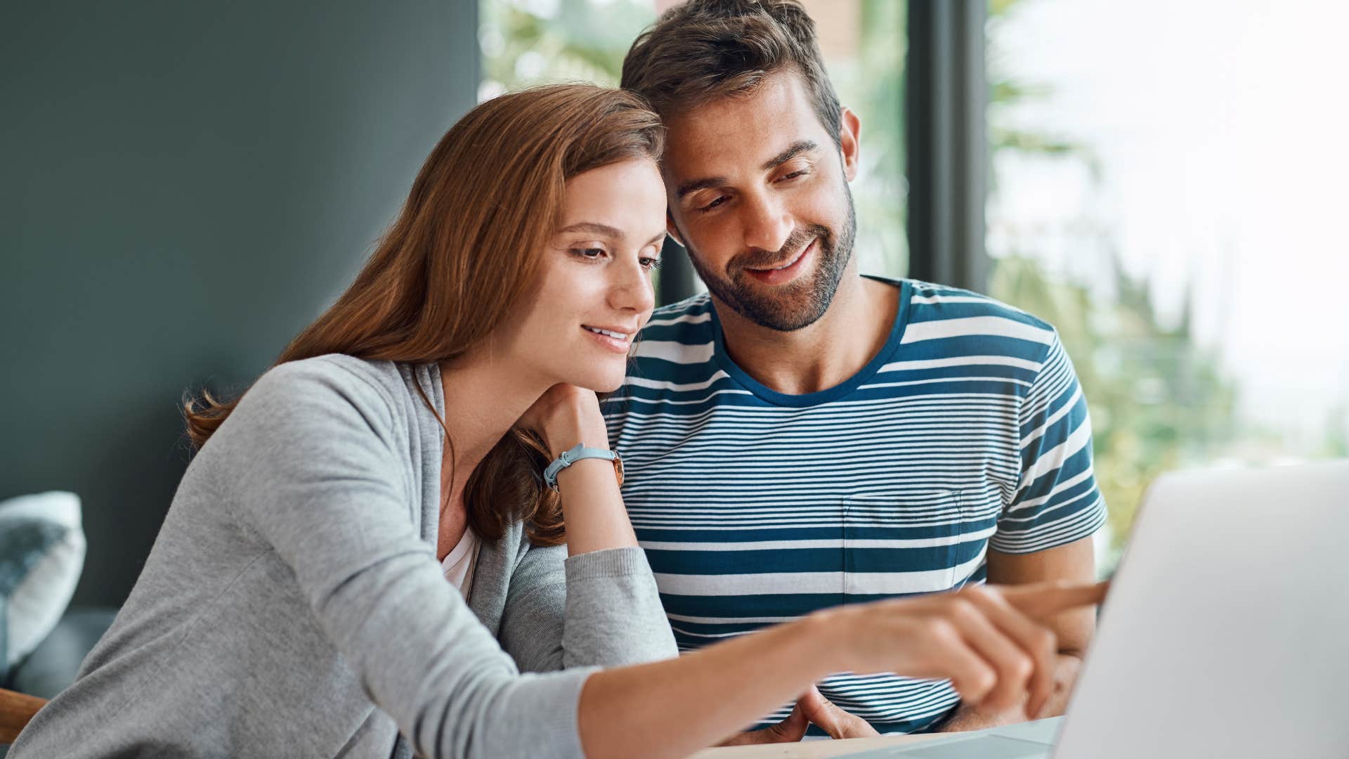 woman checking in regularly with her partner looking at a laptop