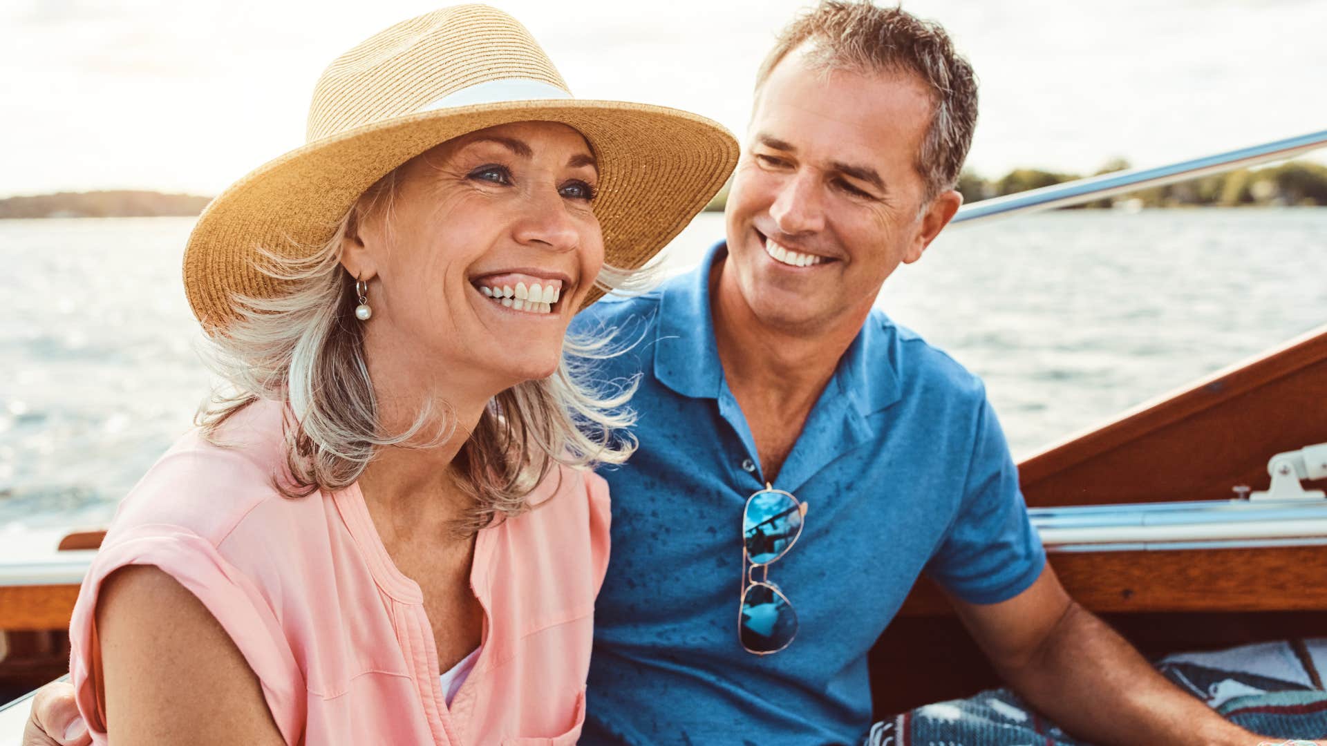 woman who's consistent with effort smiling next to her husband on a boat