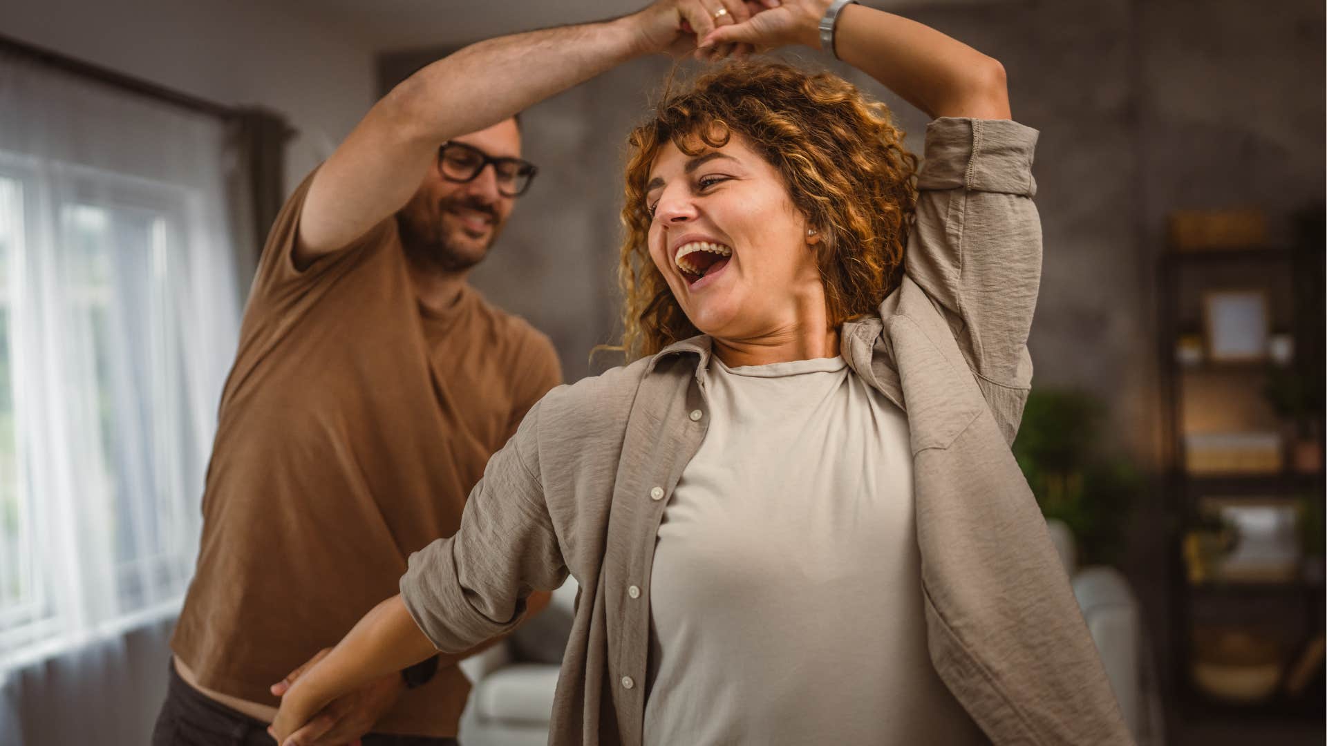 woman who's vulnerable and open dancing with her partner