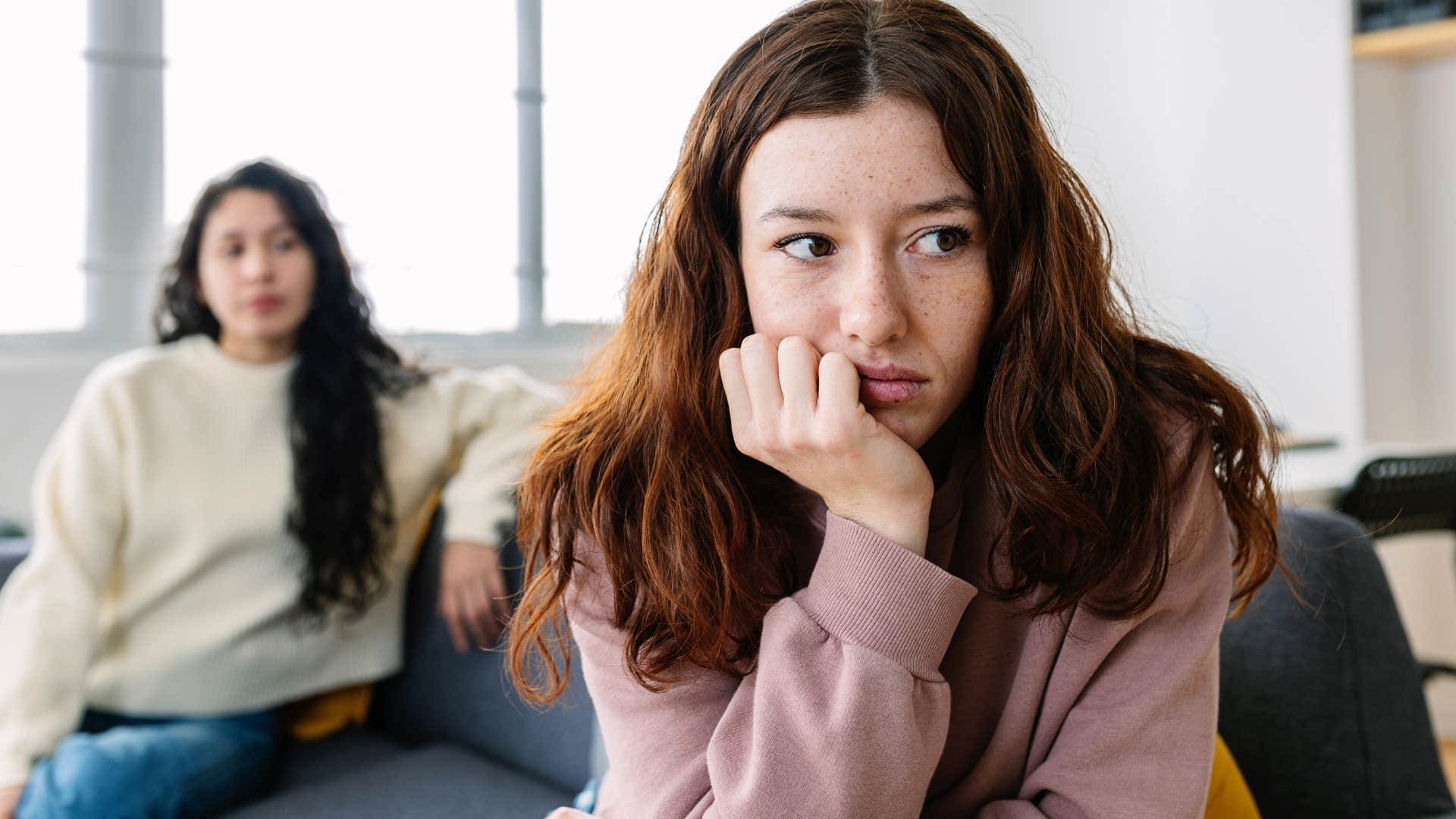 woman sensitive to criticism turned away from her friend