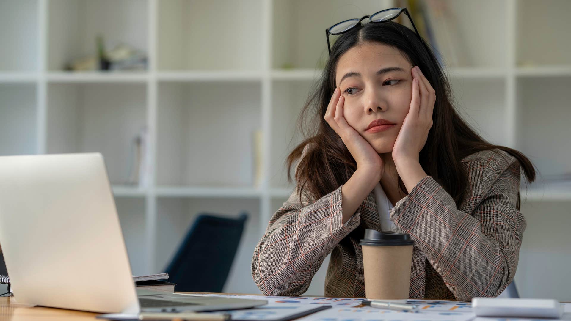 woman dreading cleaning out her inbox on laptop