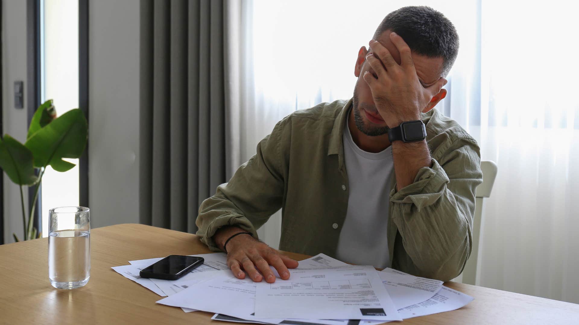 stressed man struggling with creating a budget