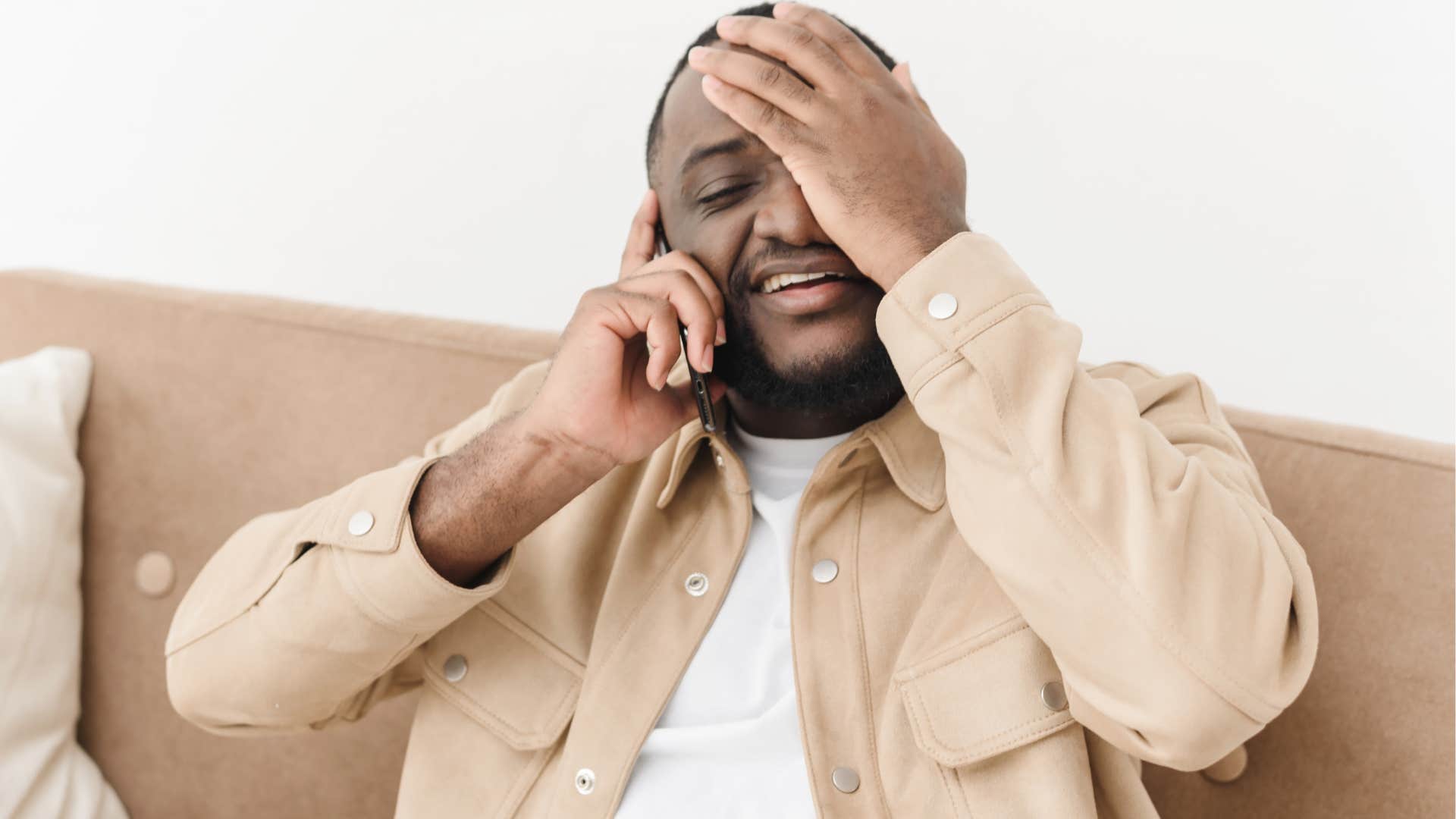 procrastinator man calling customer service on his couch