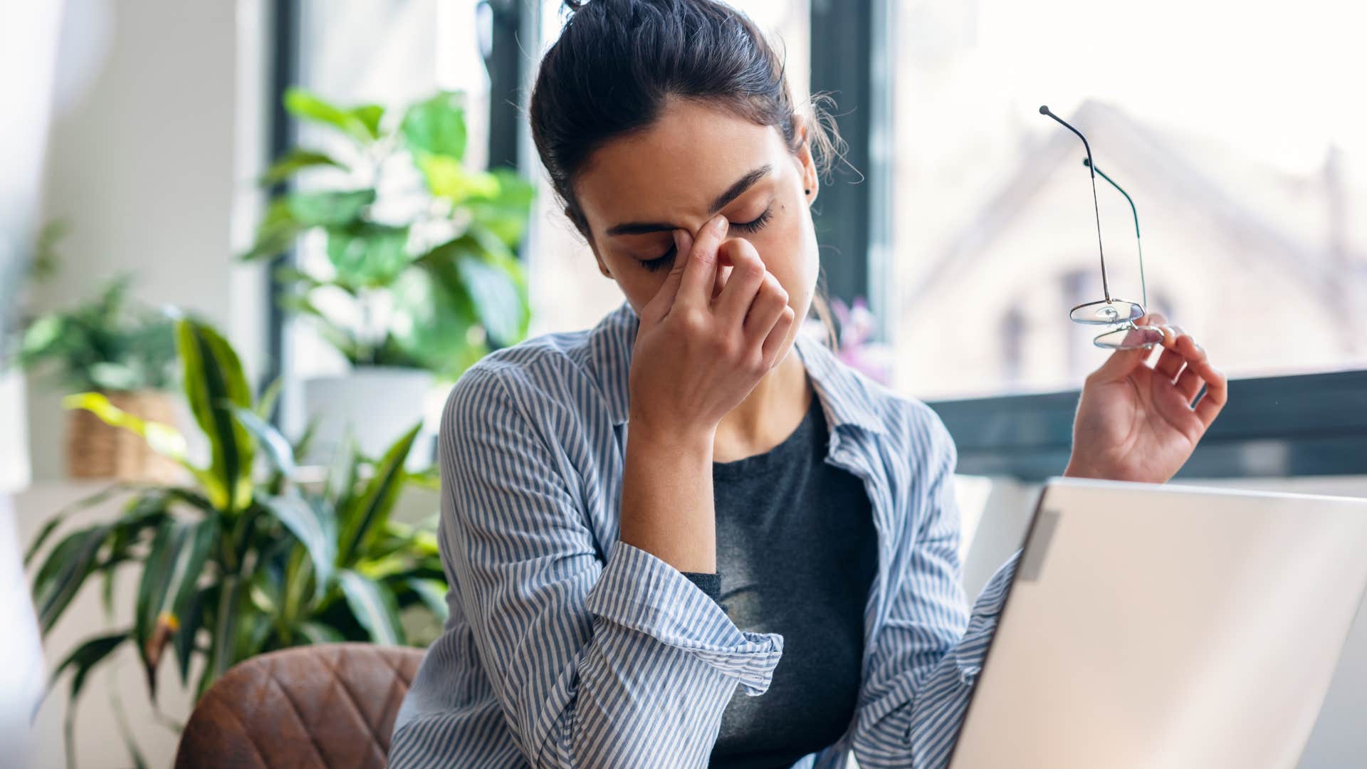 stressed woman putting off networking in her office