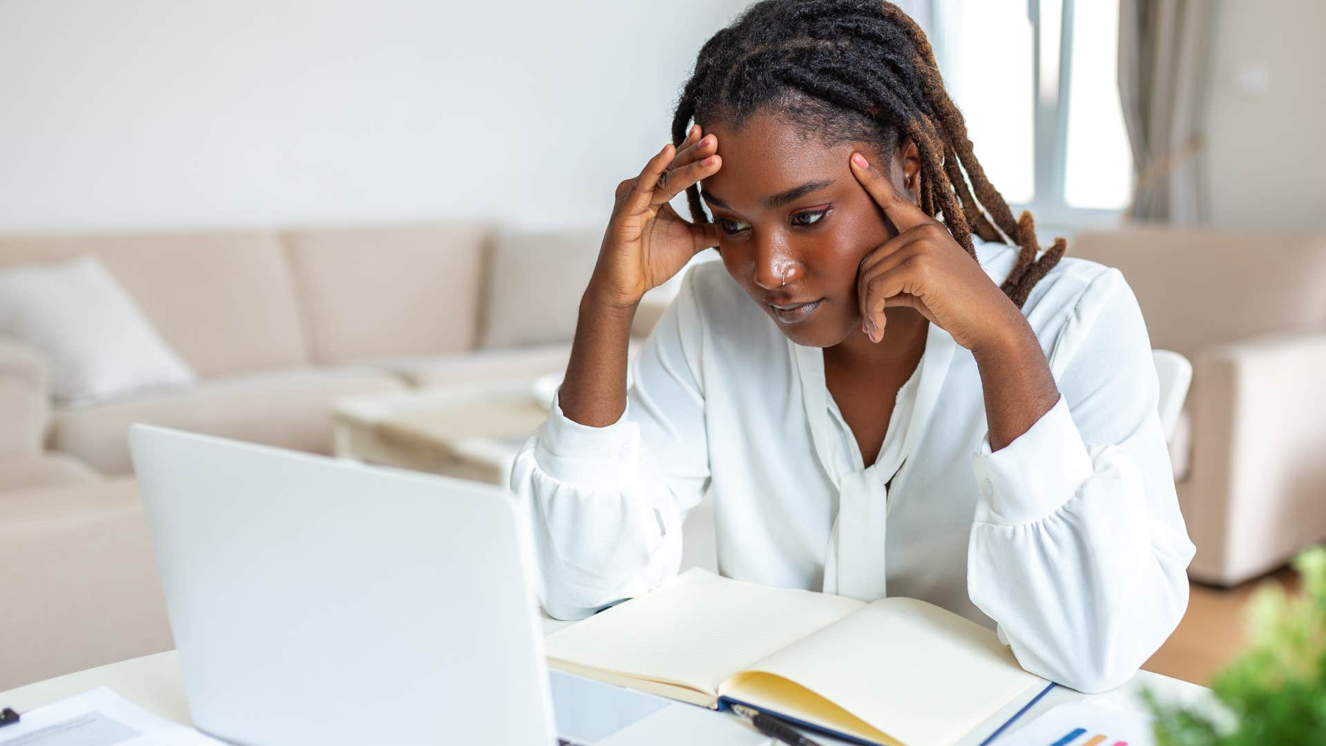 bored woman reading required materials at home after procrastinating