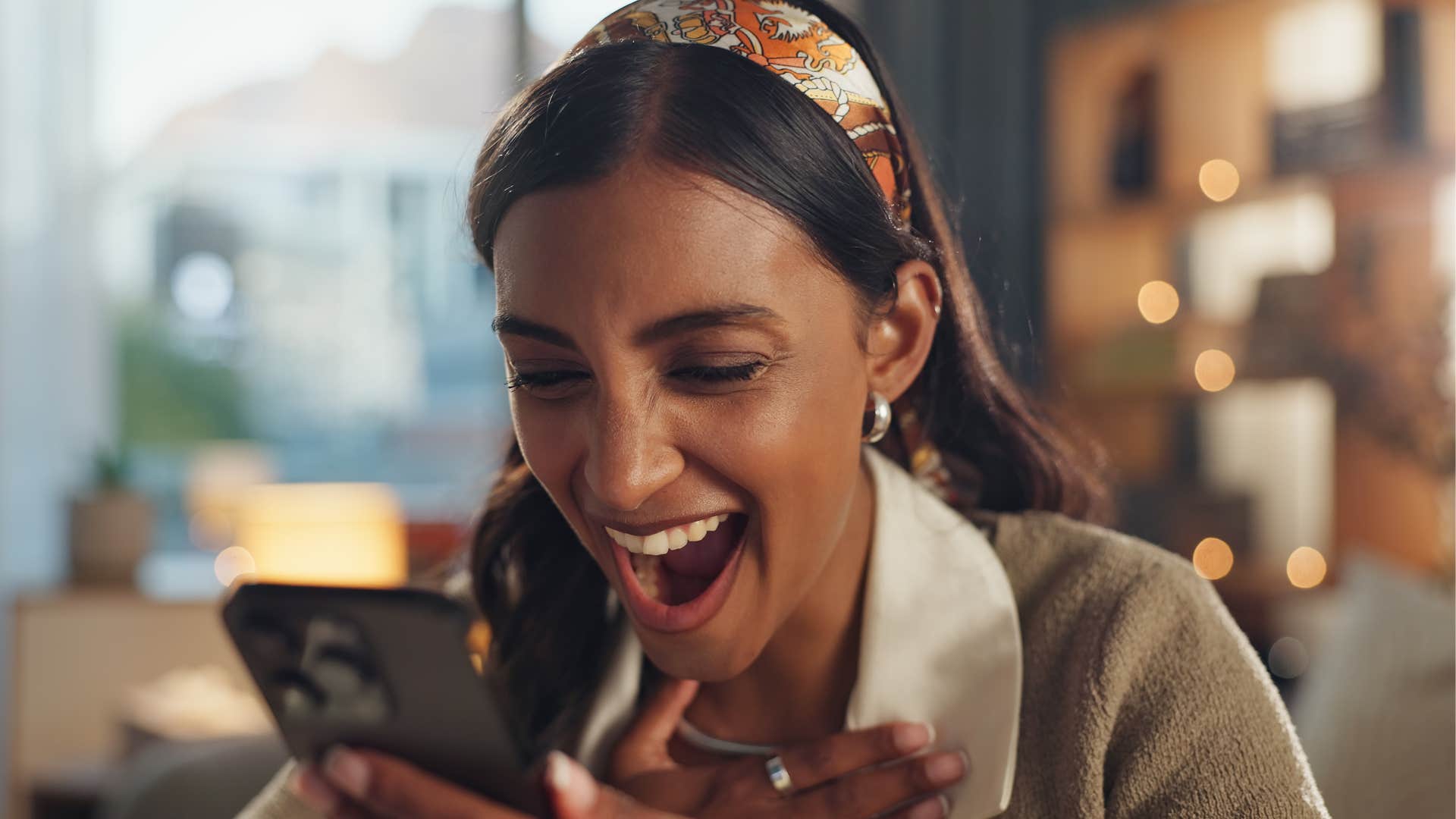 a smart woman laughs at her own joke before sending it