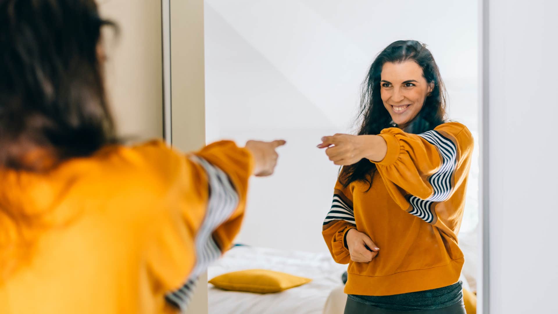 a smart woman is talking to herself in the mirror
