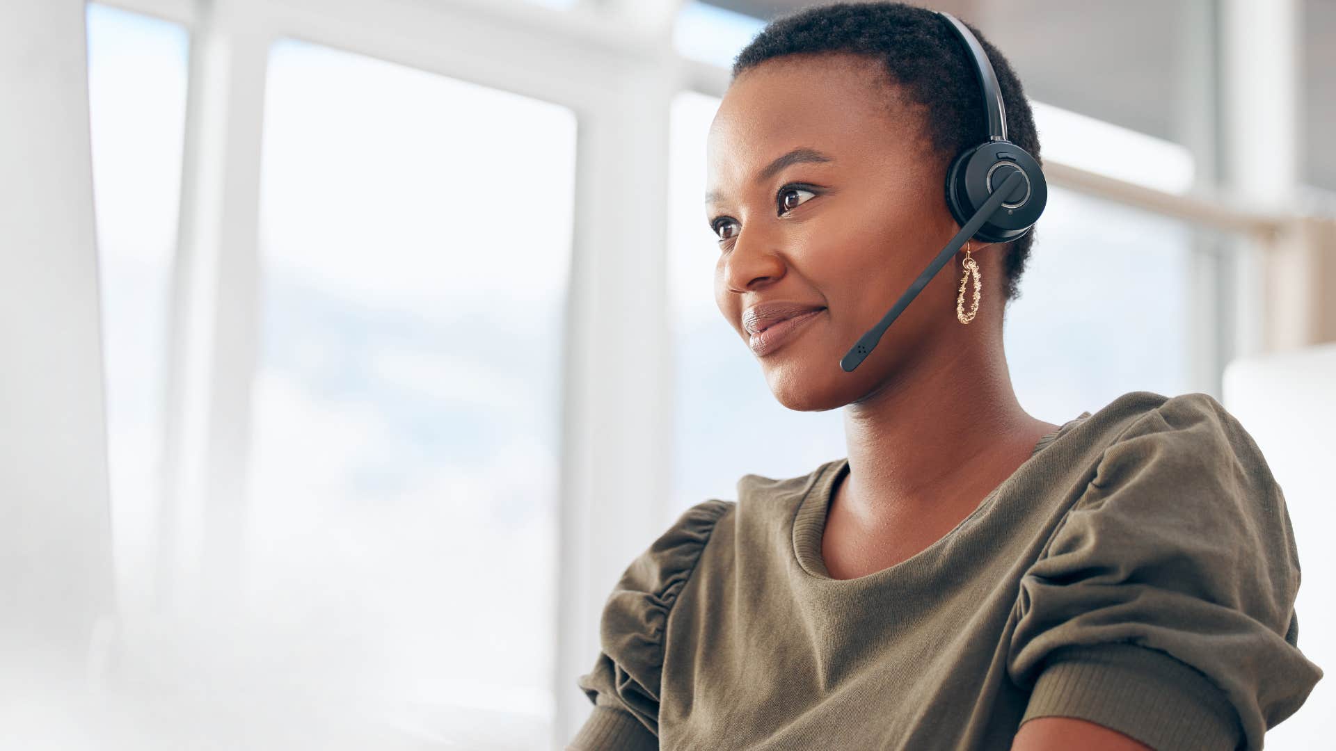 powerful woman with headset pausing before she speaks
