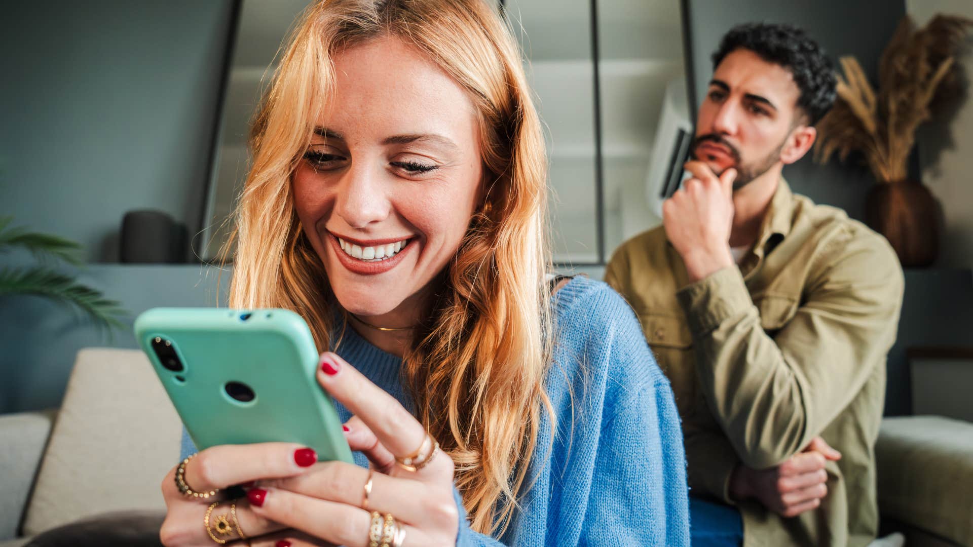 man looking at his wife who's constantly distracted by her phone