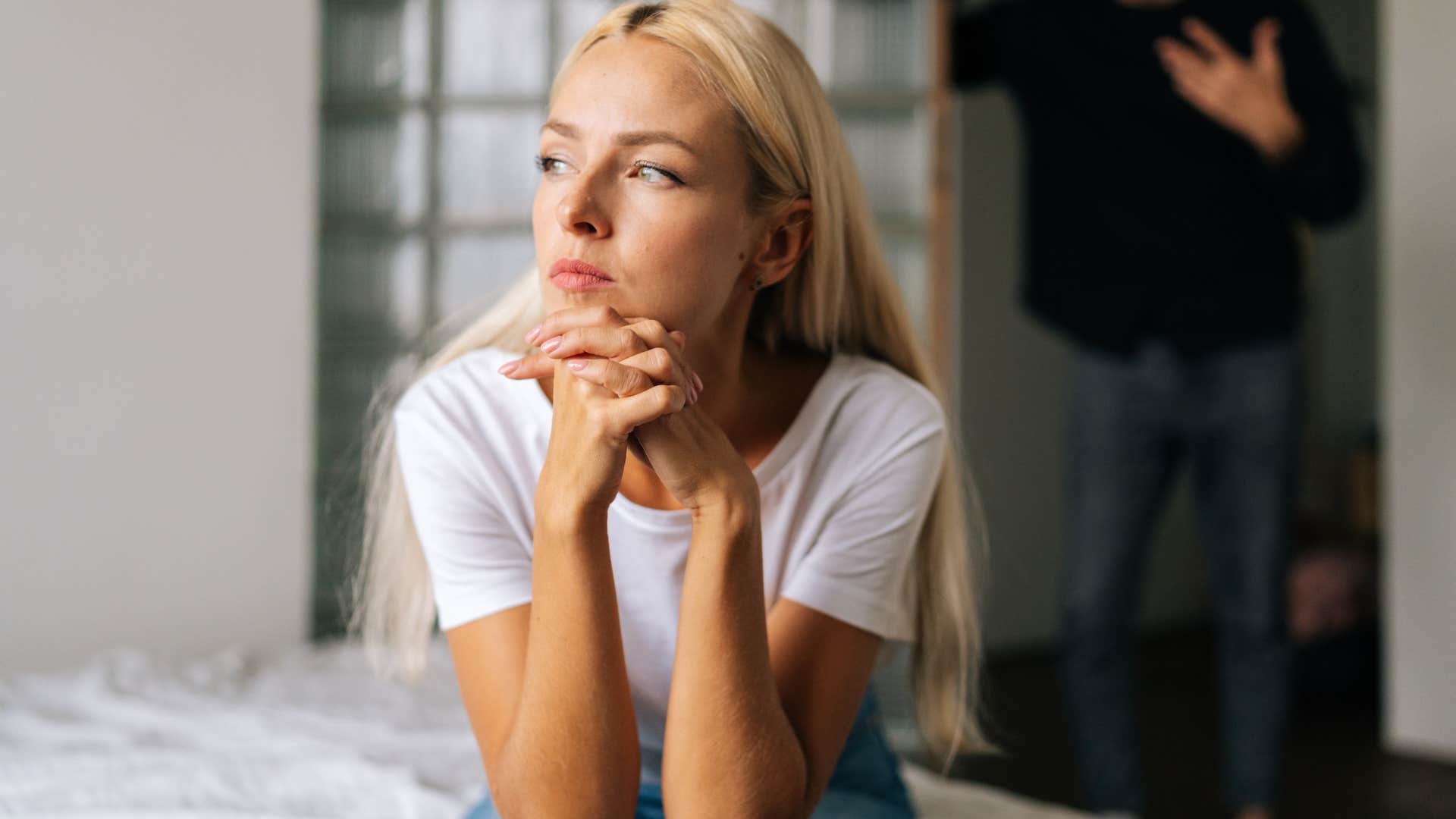 man standing behind his wife who never goes out with him