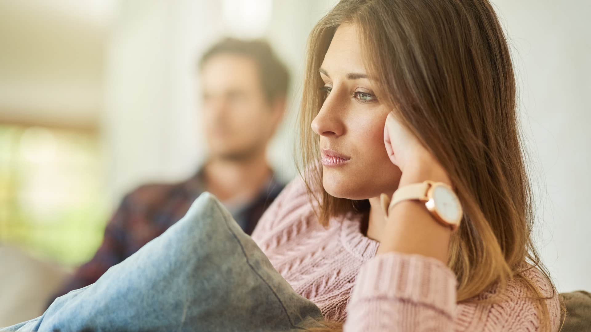 upset woman who spends more time alone sitting next to her husband
