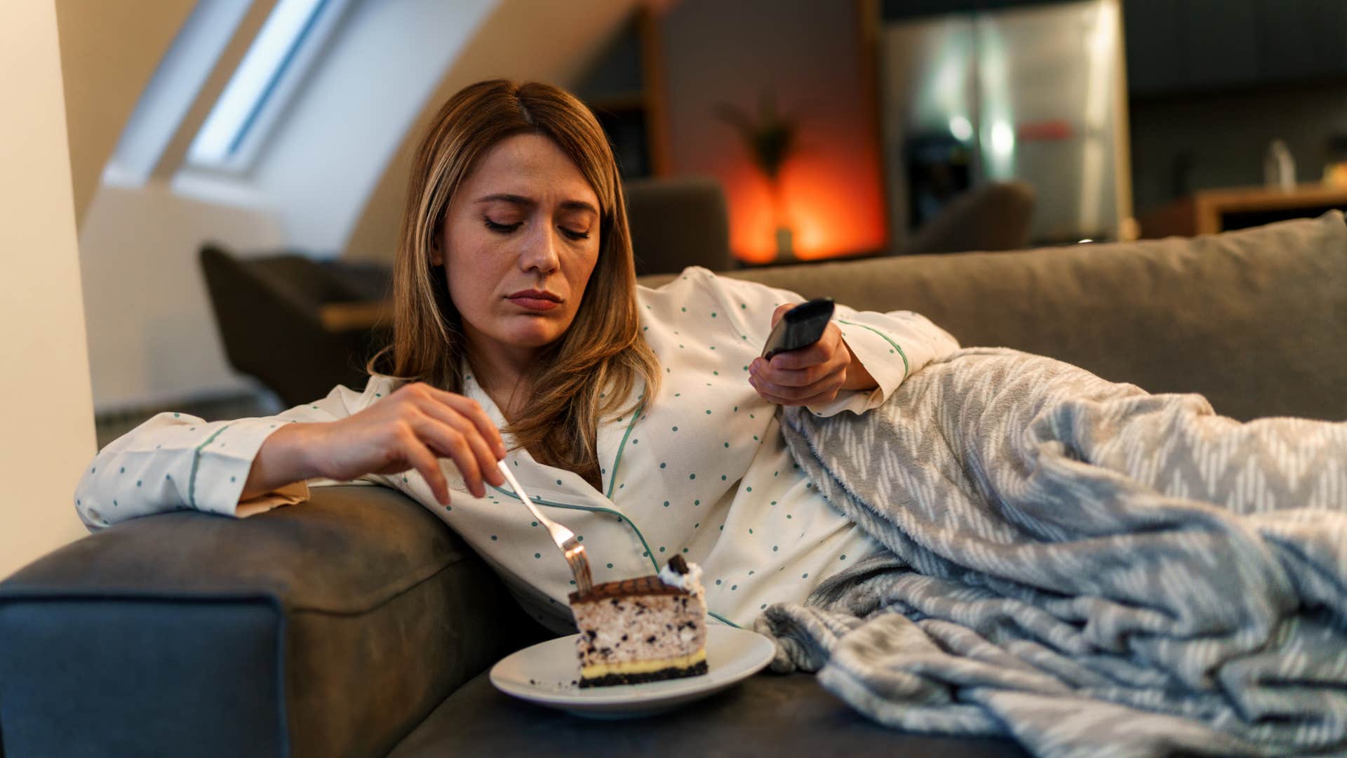woman eating unhealthy cake instead of nutritious food
