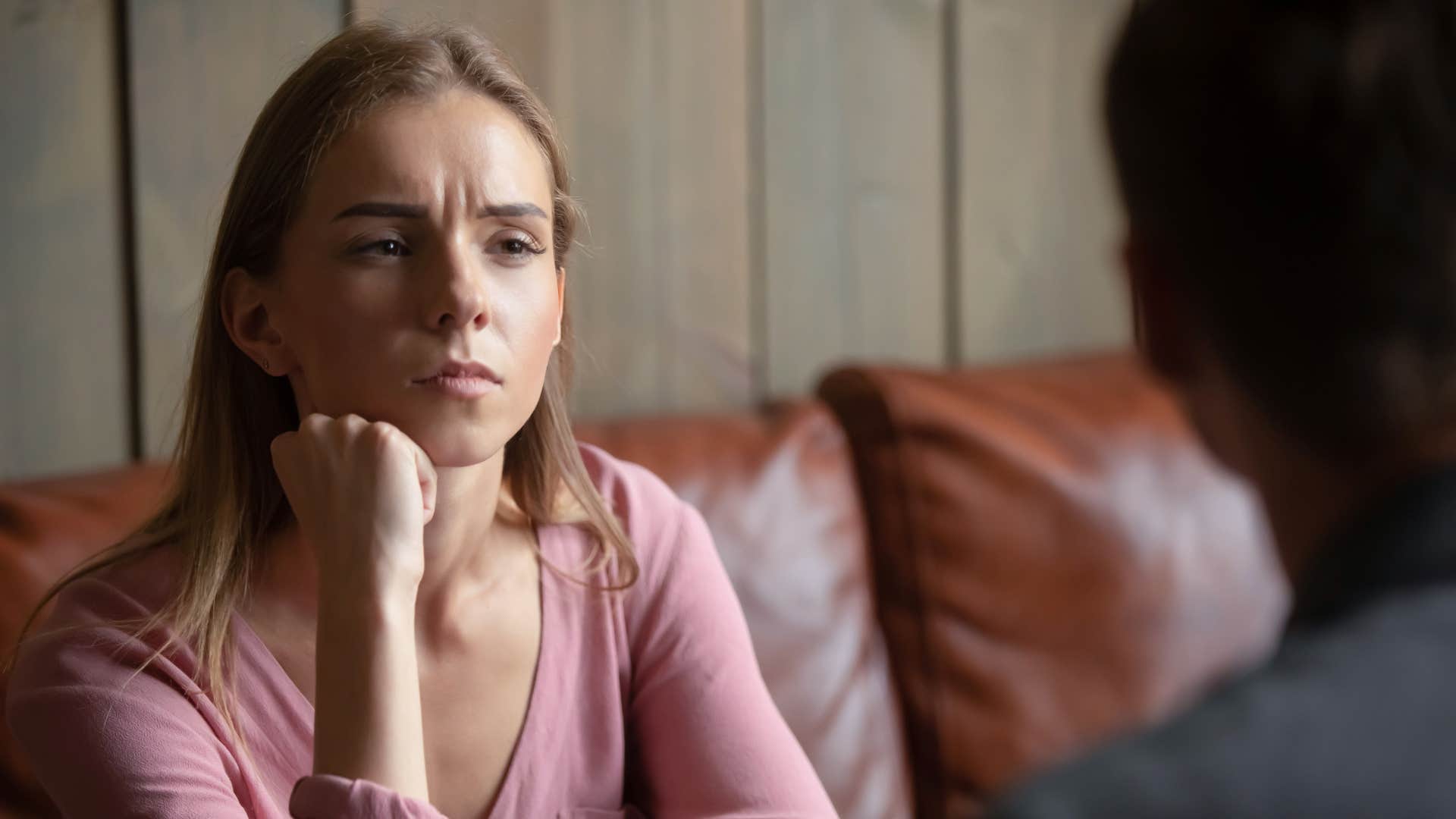 bored woman zoning out while maintaining eye contact with friend