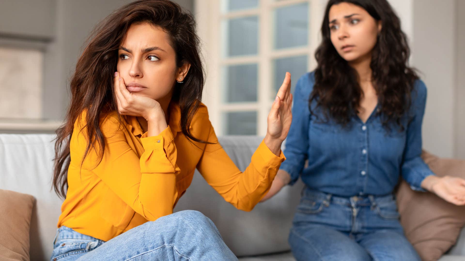 Woman turned away from her friend who can use backhanded compliments.