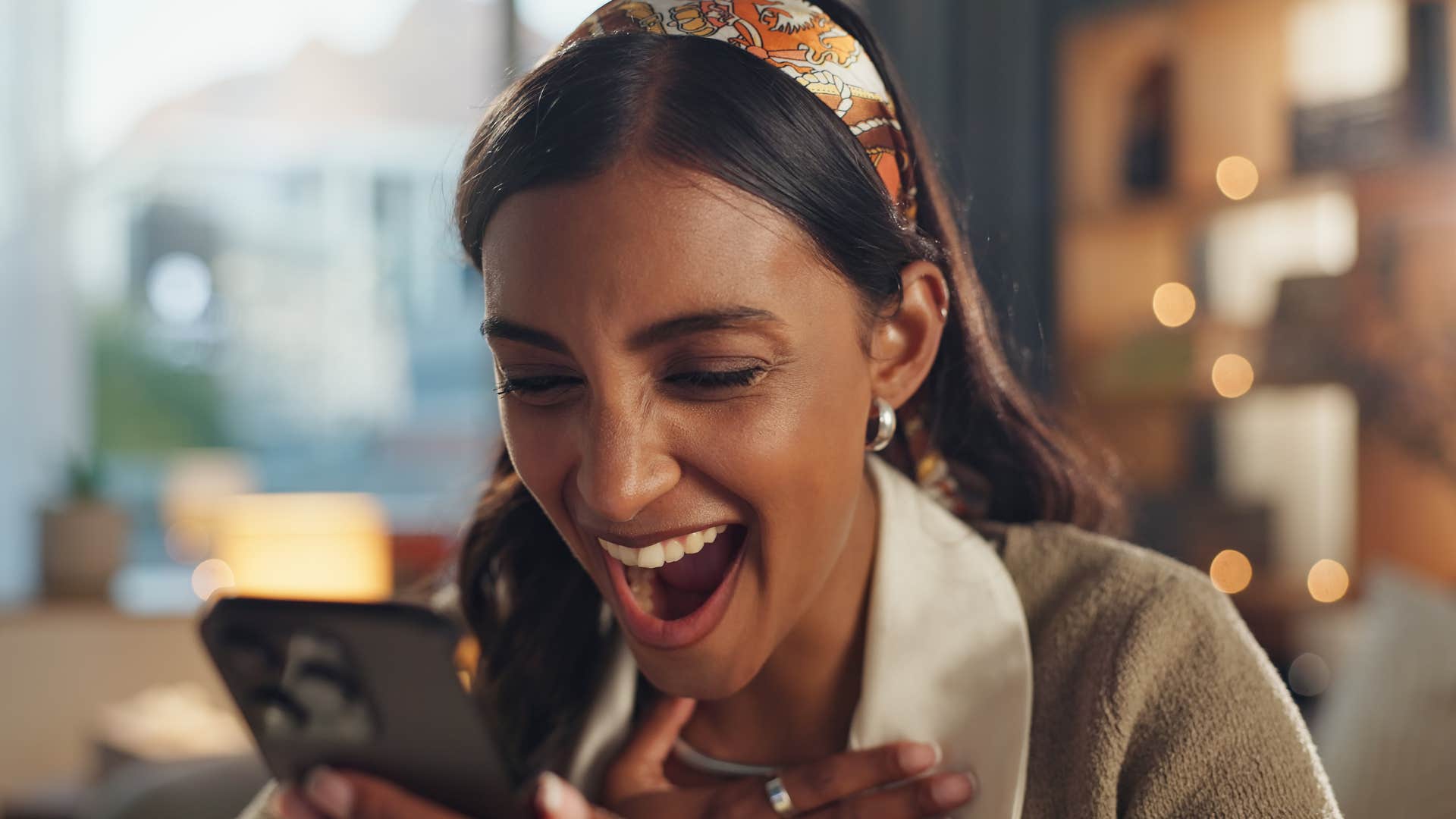 Woman looking at a text that's spreading rumors behind their back.