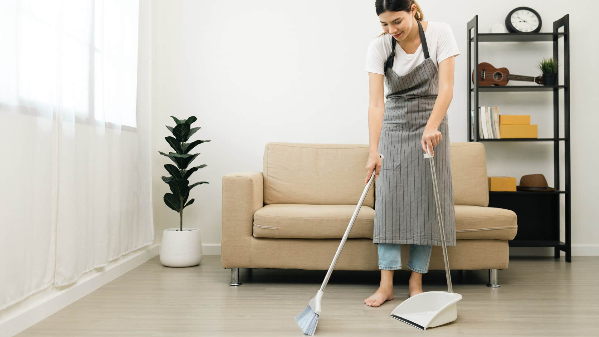 woman sweeping with a broom