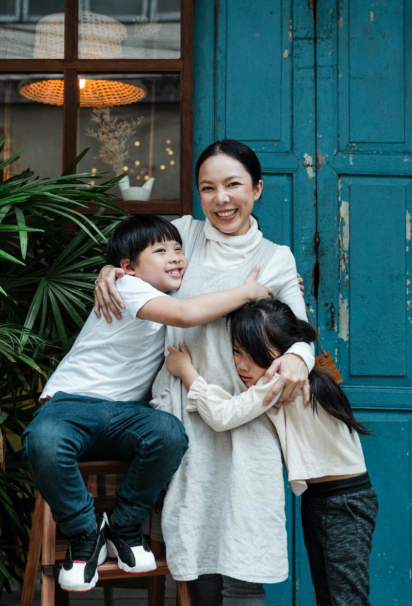 mom hugging kids talking mom phone just good getting hug research