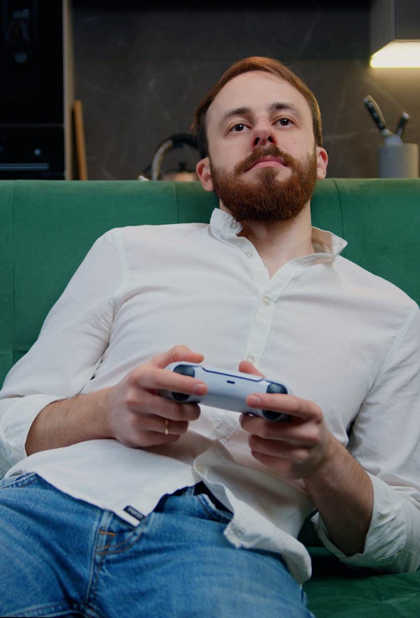 depressed man playing video games