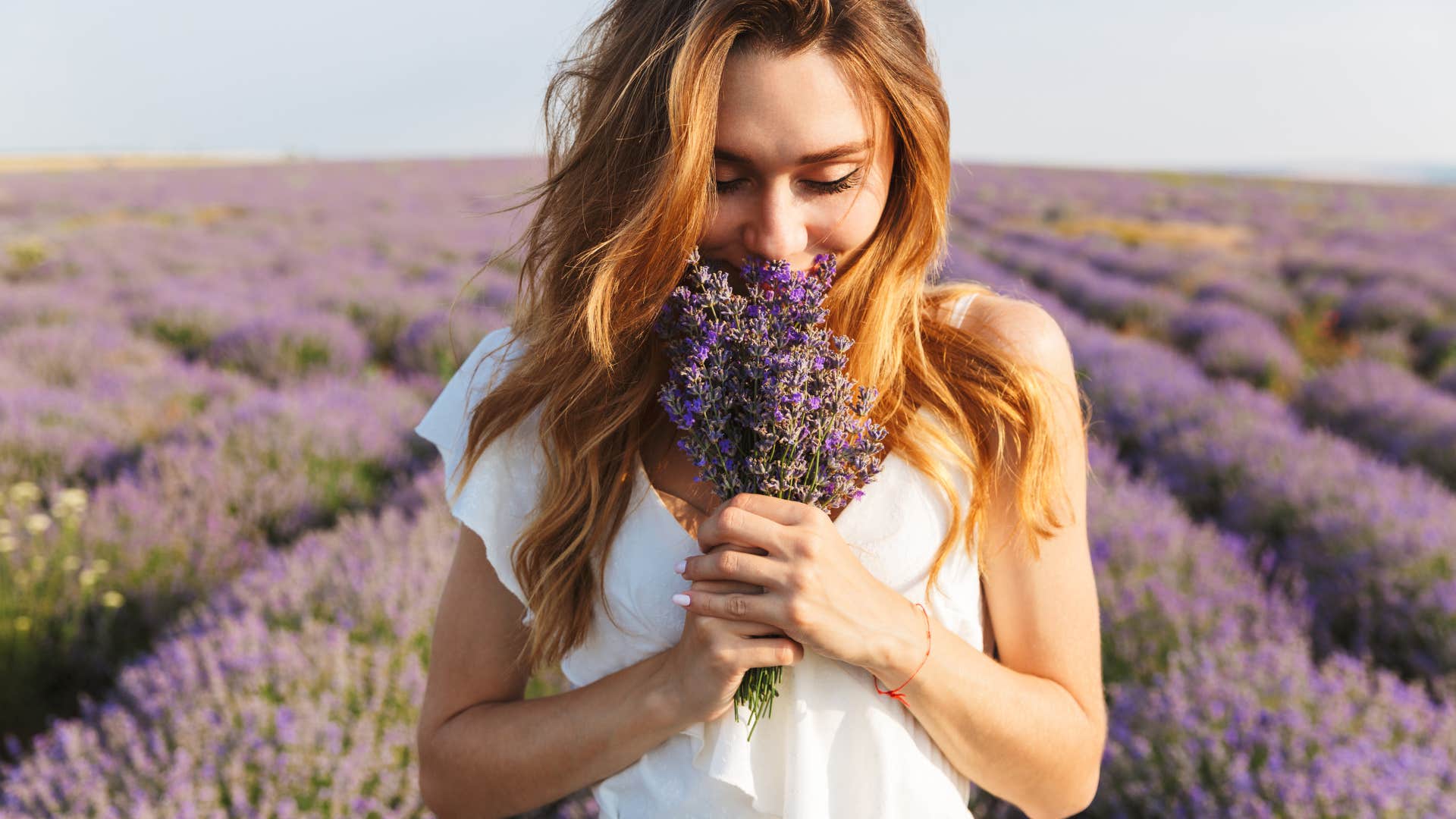 woman with the everyday habits smelling lavender