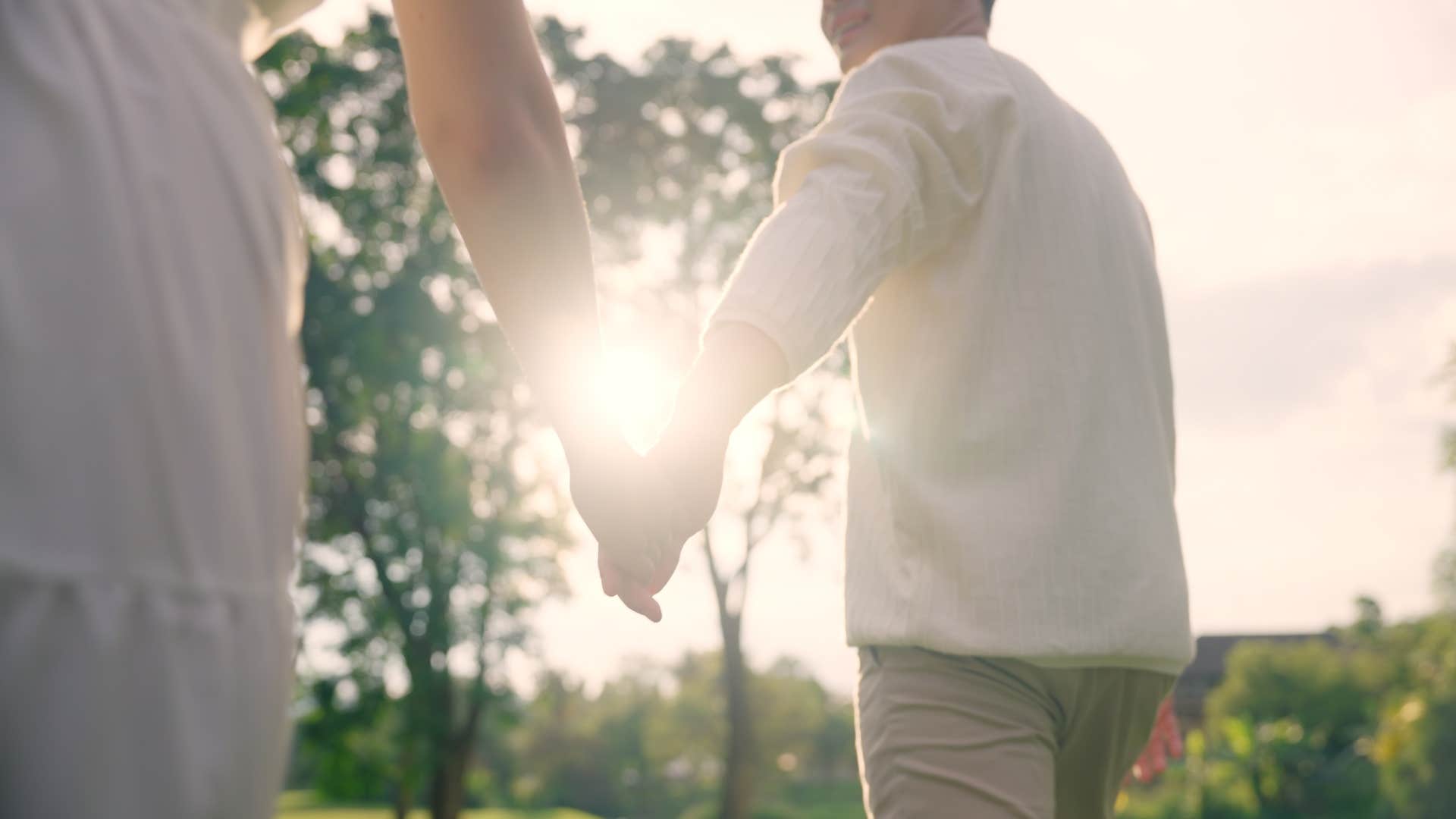 couple holding hands to ease pain as fact about love