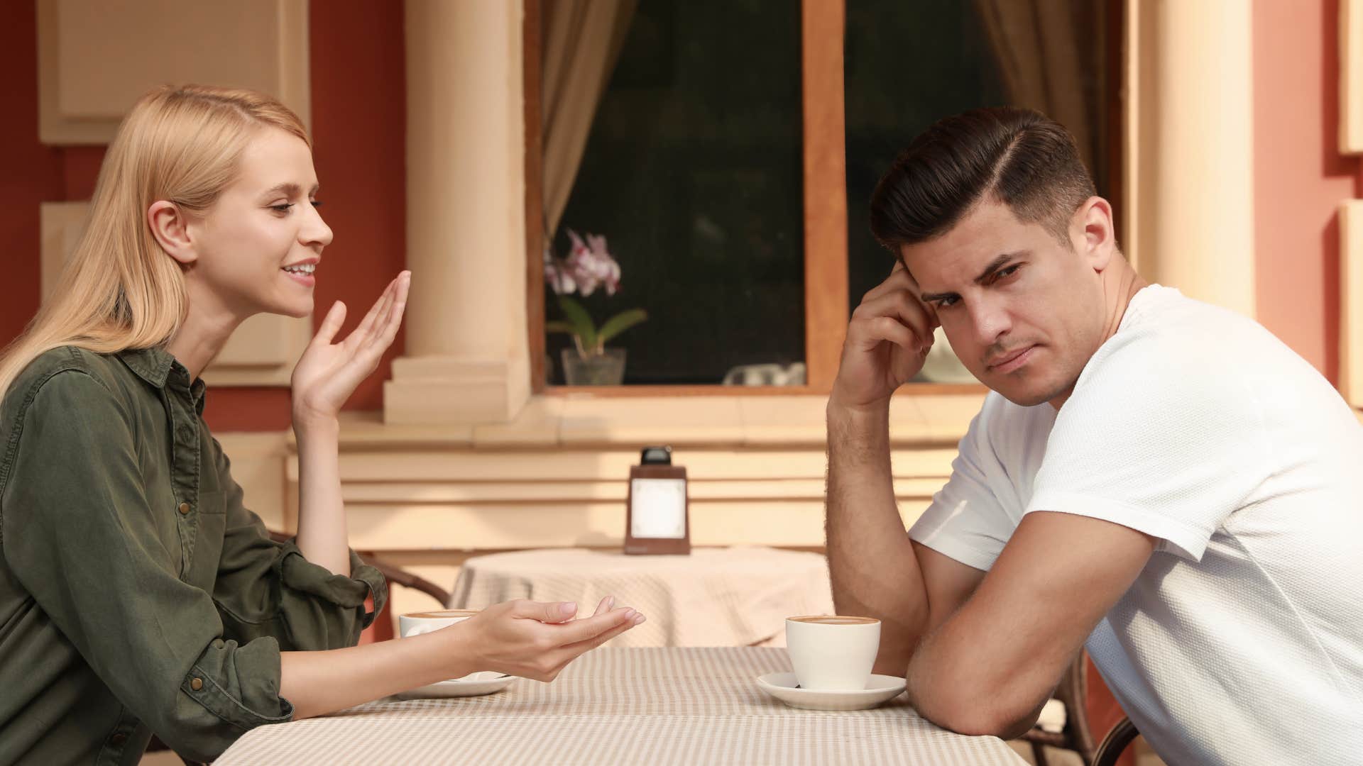 man secretly grossed out because woman is eating with her mouth open