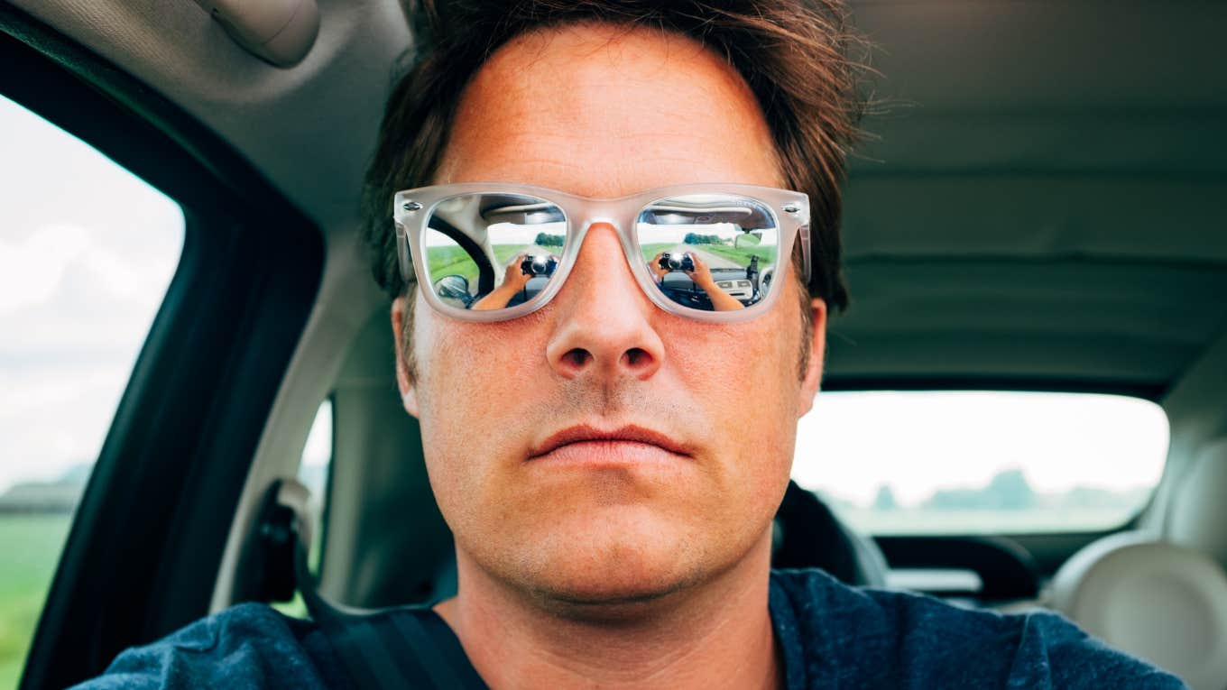 Things About Cheaters That Are Way Weirder Than Anyone Wants To Admit Cheating man taking a selfie while in his car.