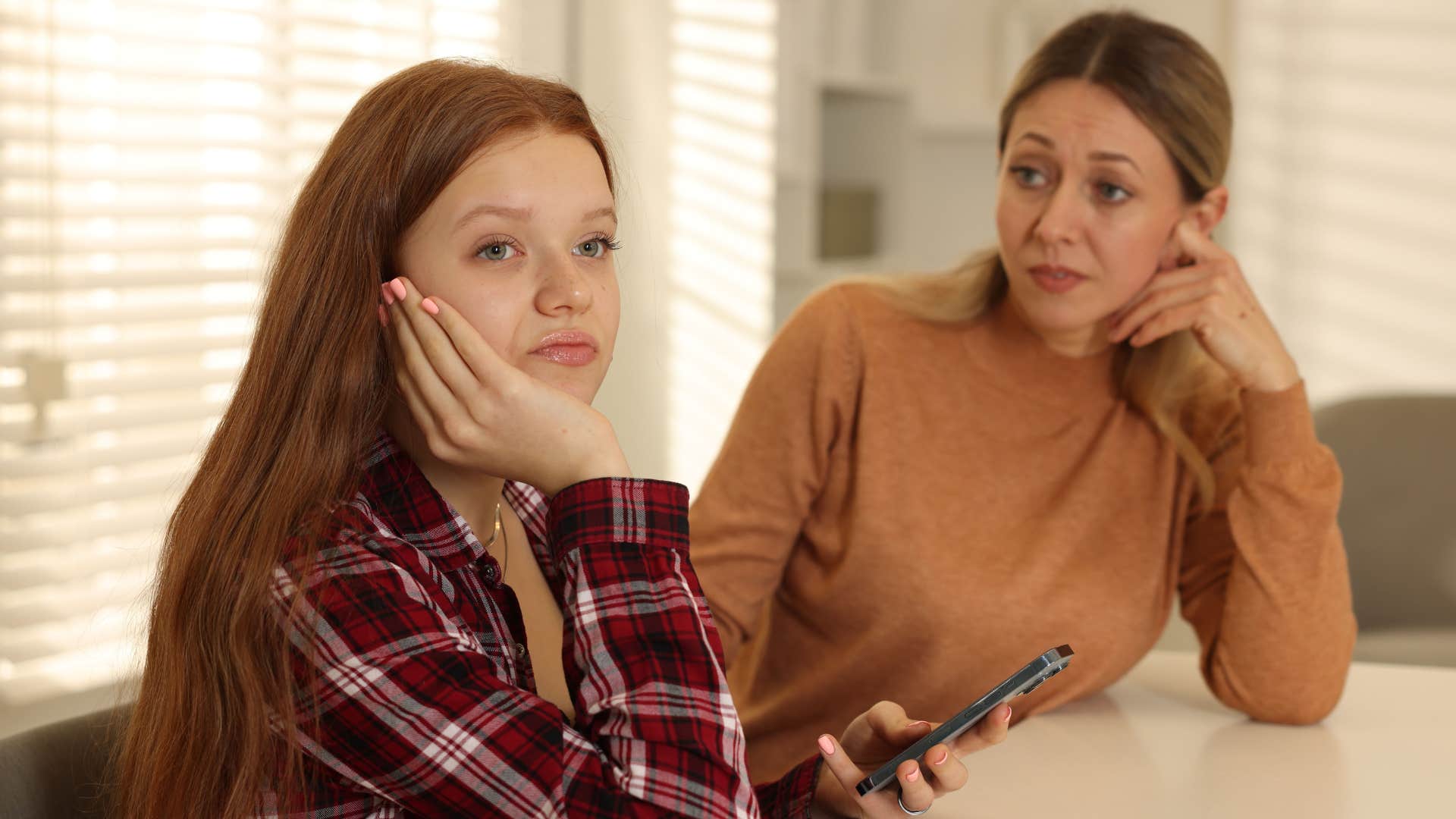 a mother tries to get her adult daughters attention because she has been distant