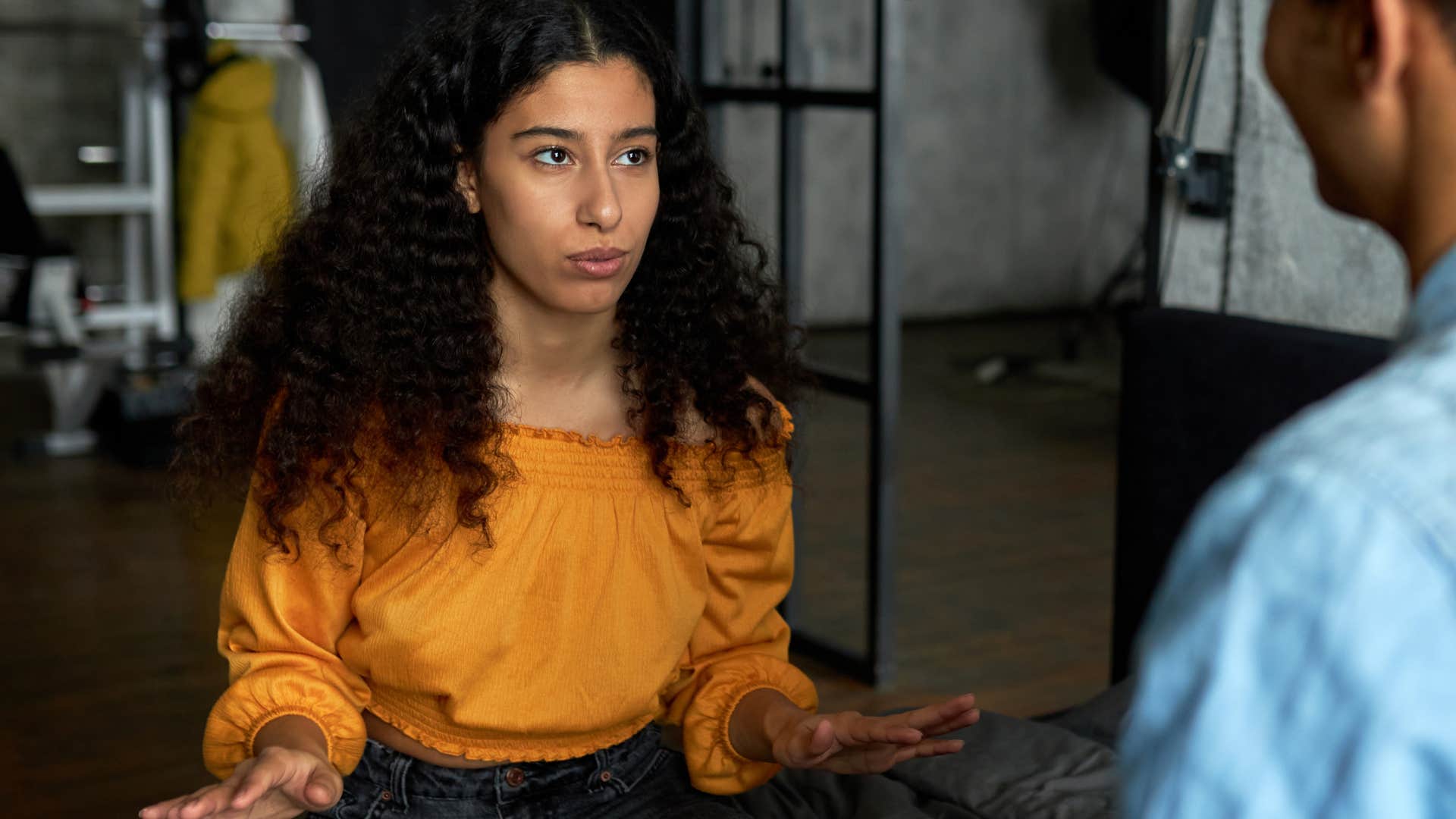 woman saying i'm just being honest to her upset partner