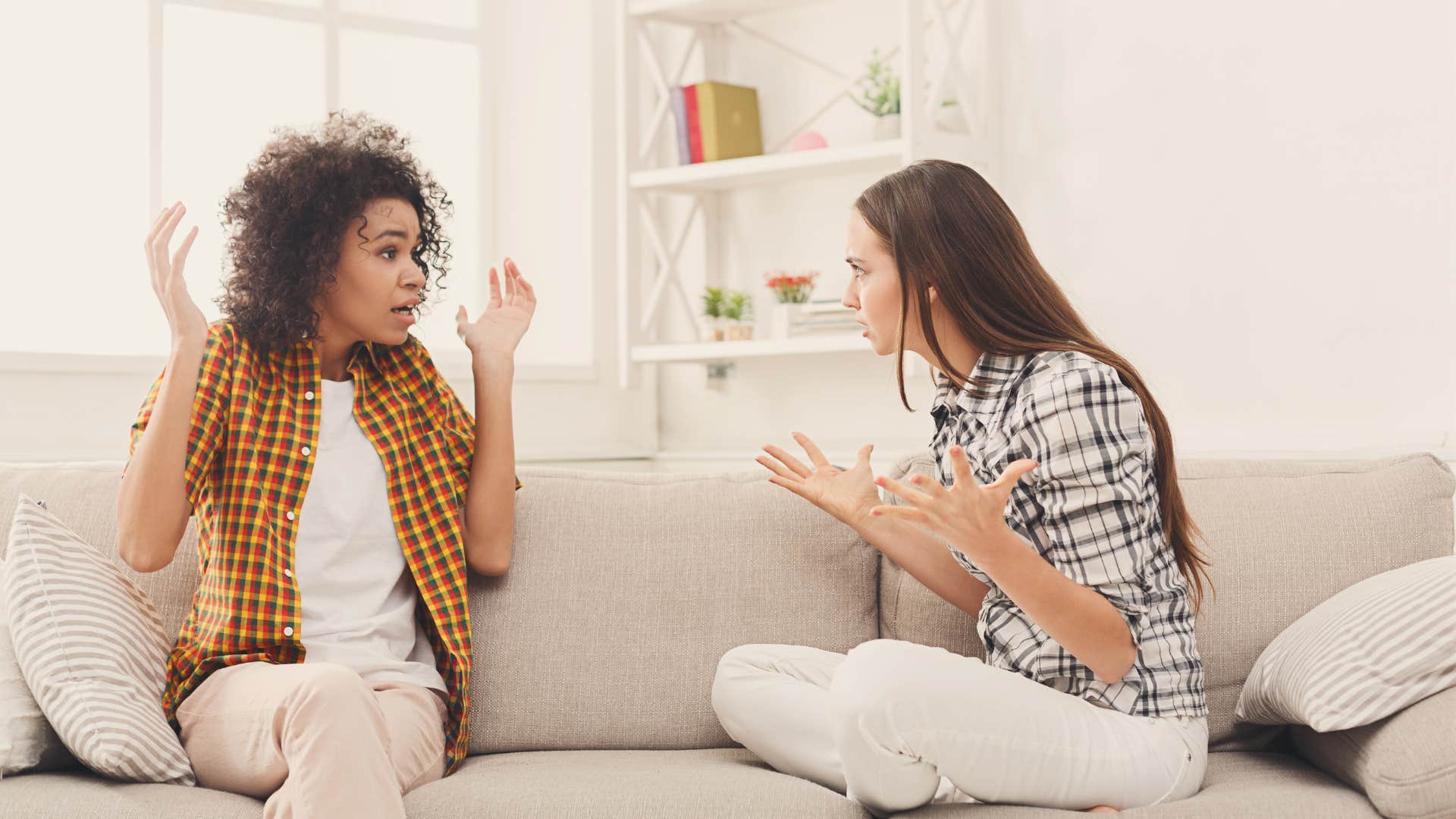 two smart women debating on a couch