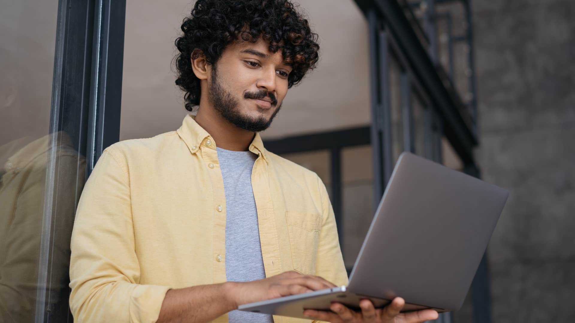 smart man writing computer code on his laptop