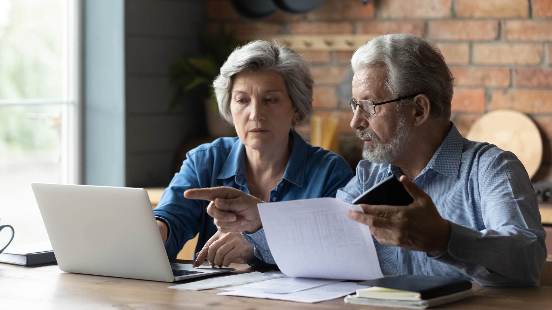 a boomer couple go over their finances to save for emergencies 