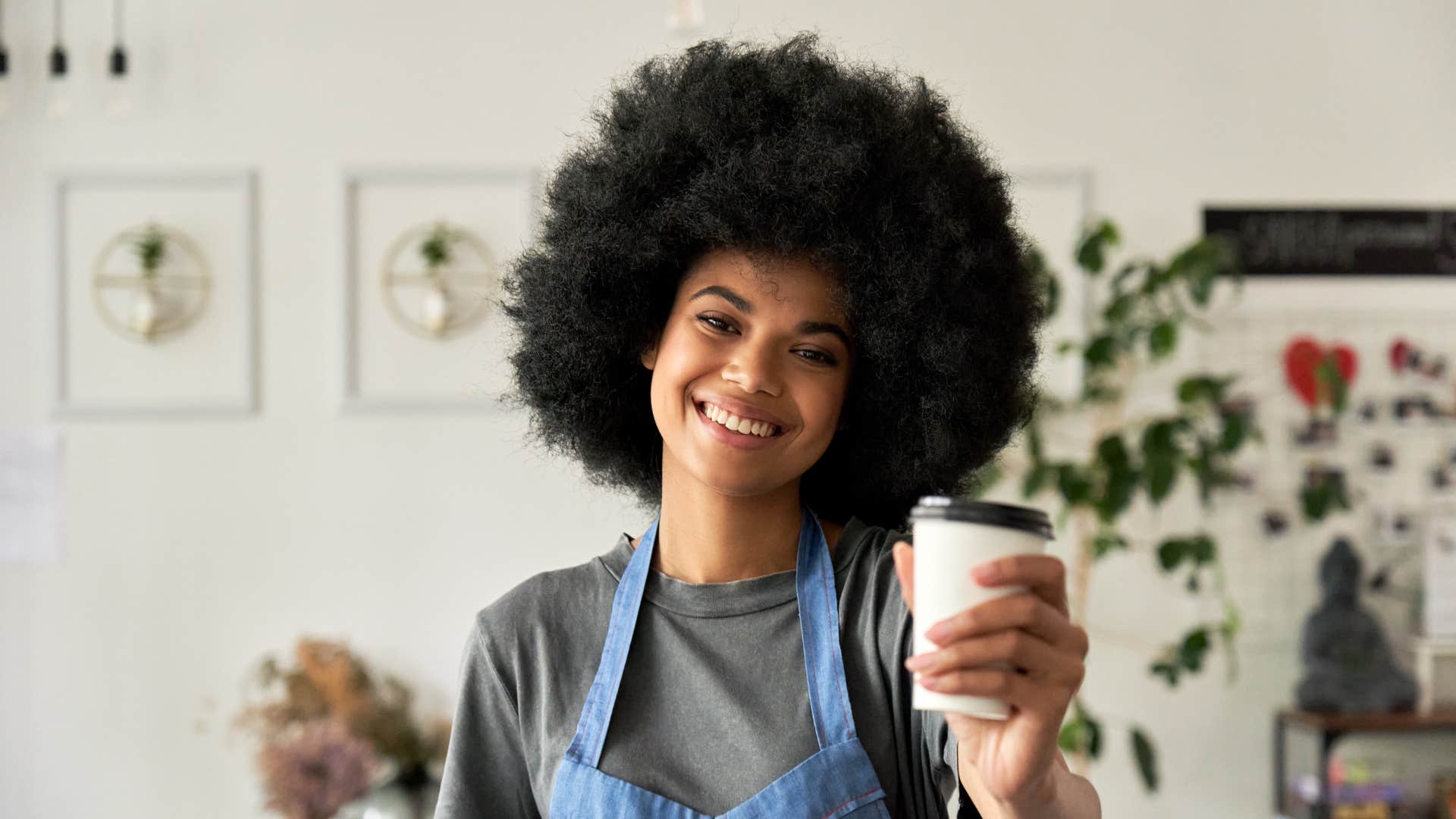 young woman holding coffee cup in cafe