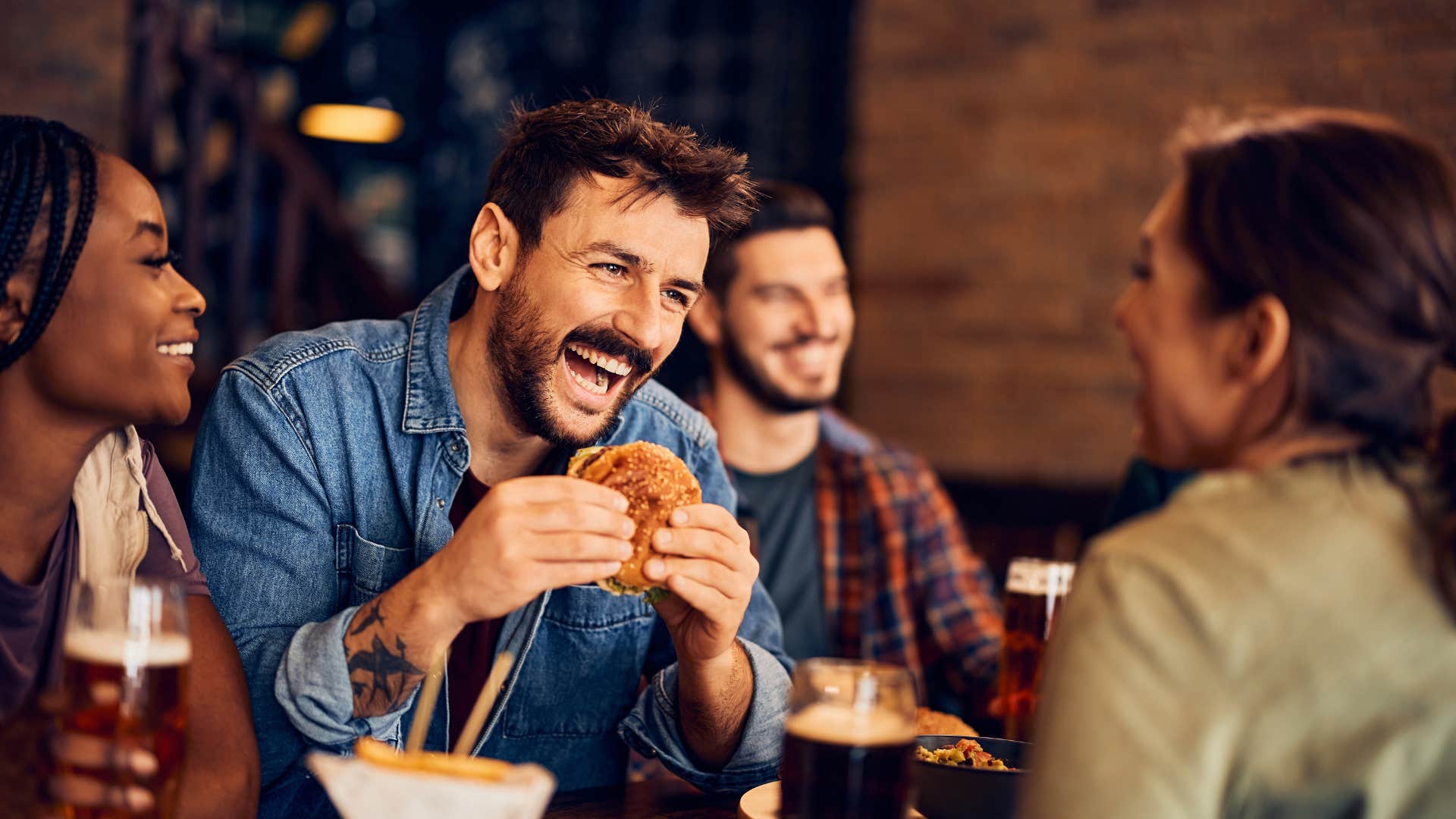 group of friends eating out at restaurant
