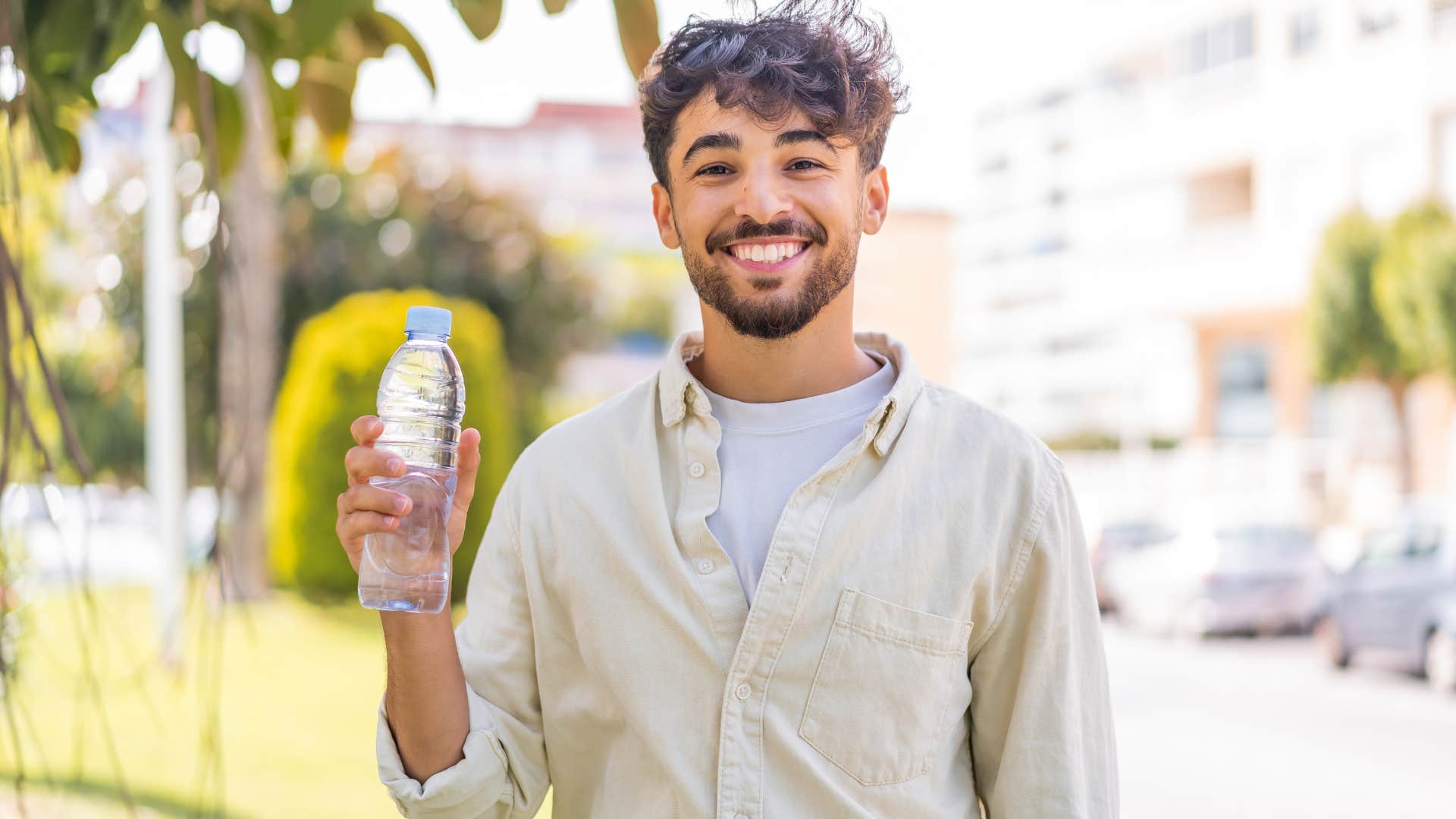 Man smiling with free stuff from public spaces.