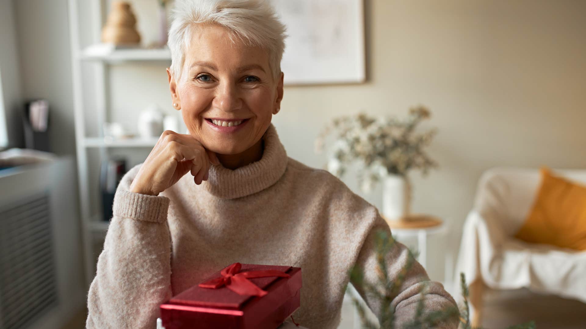Woman smiling with her re-gifting presents.