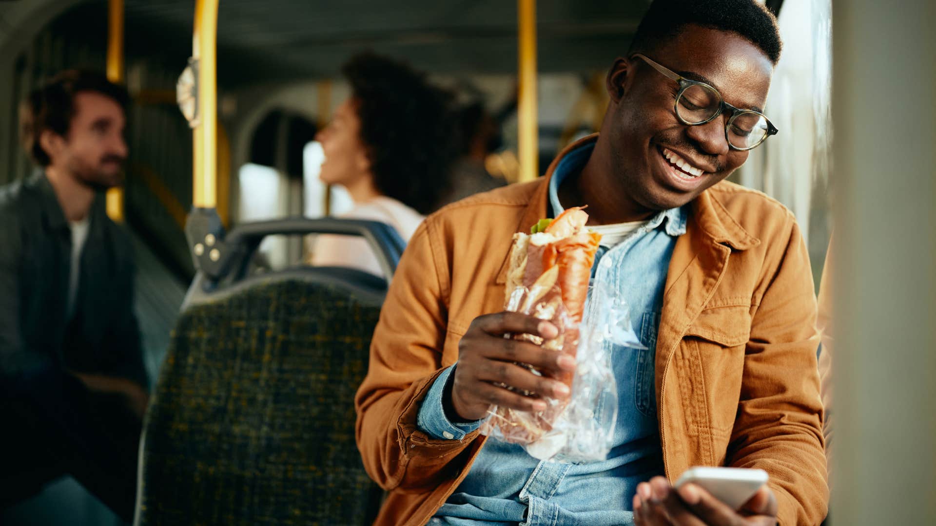 Man eating a sandwich after sneaking food into events.