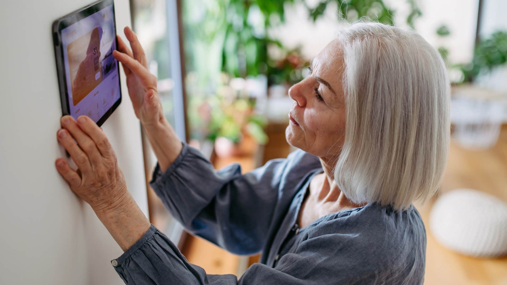 Woman turning off the thermostat with guests over.