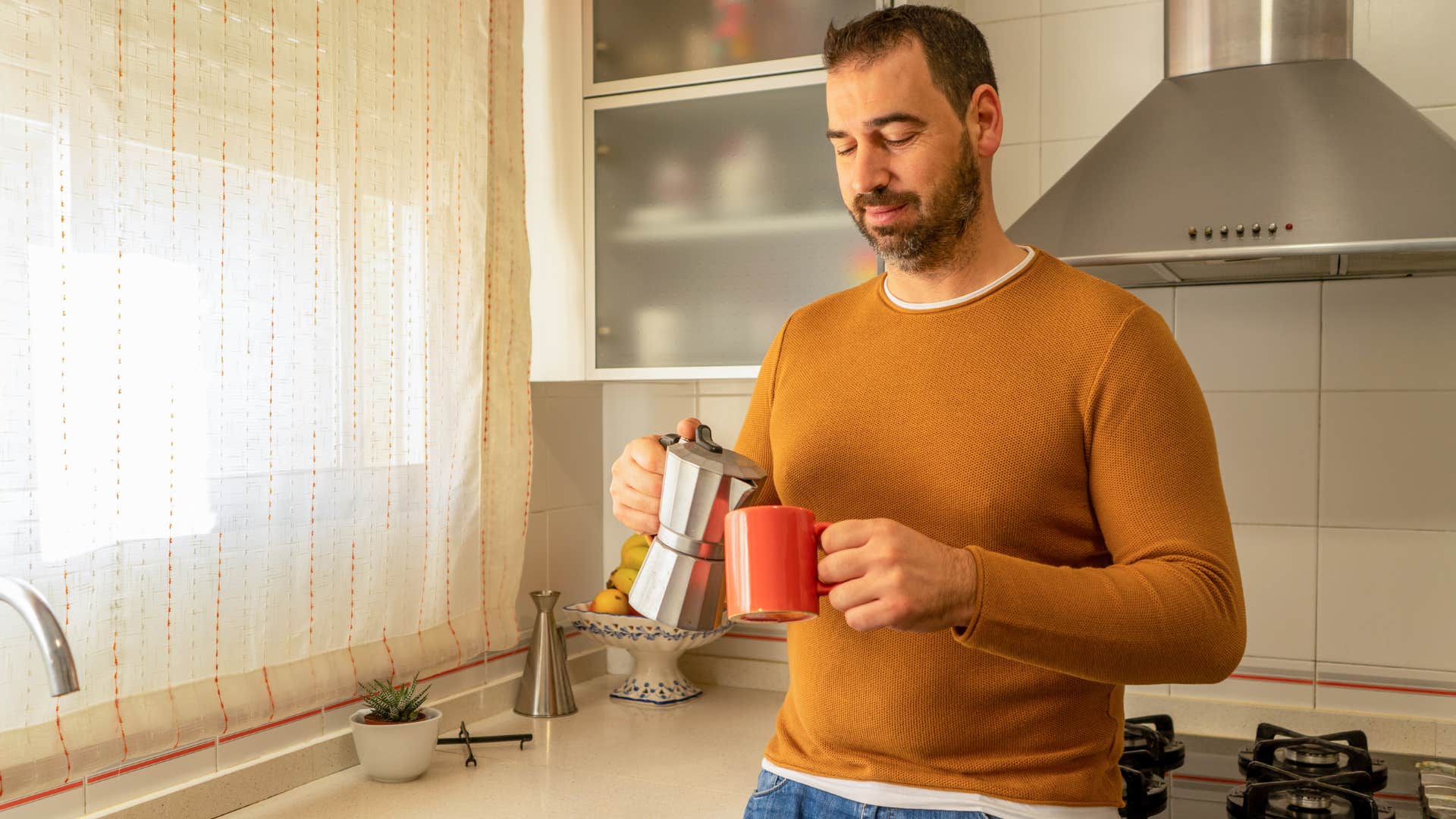 man pouring coffee into a cup from a quality coffee maker