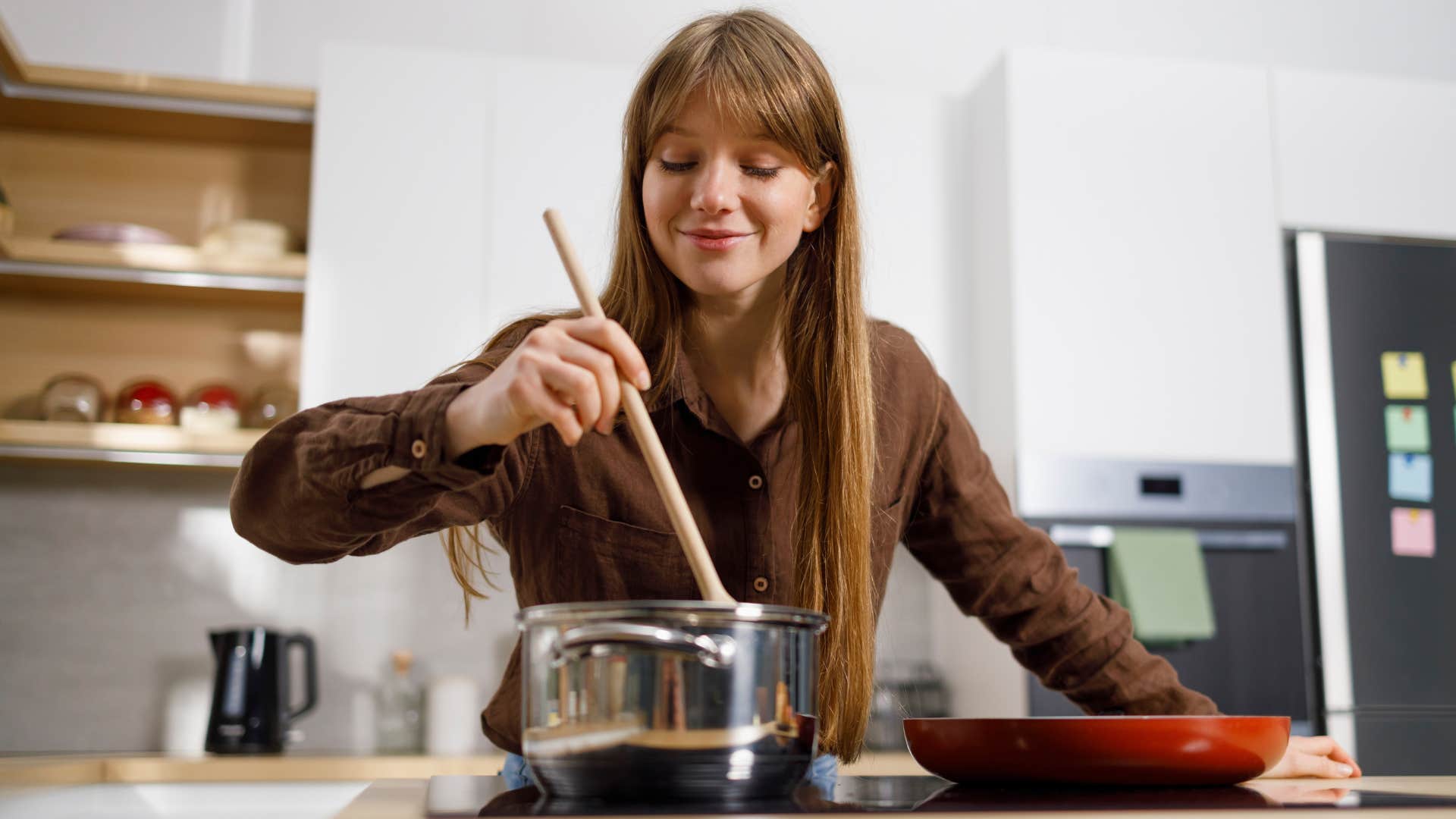 frugal woman using her old cookware to make food