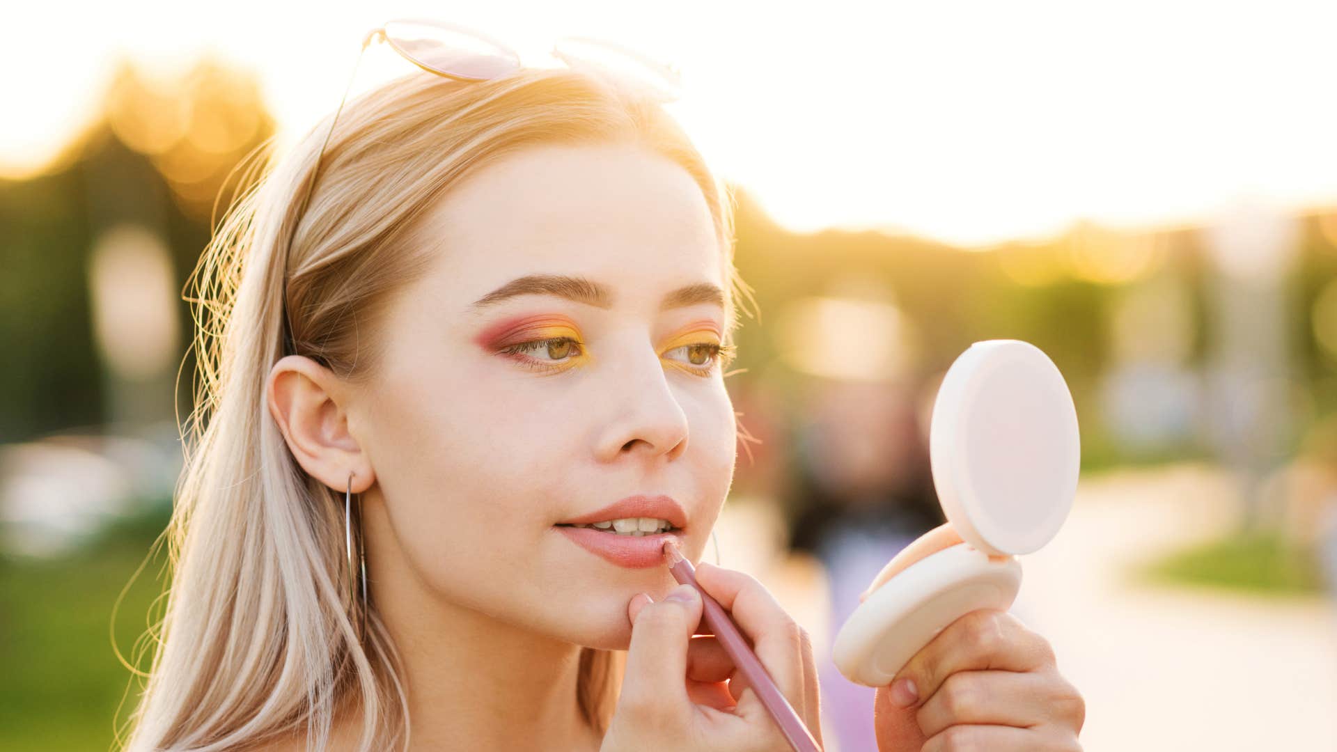 frugal woman applying old makeup