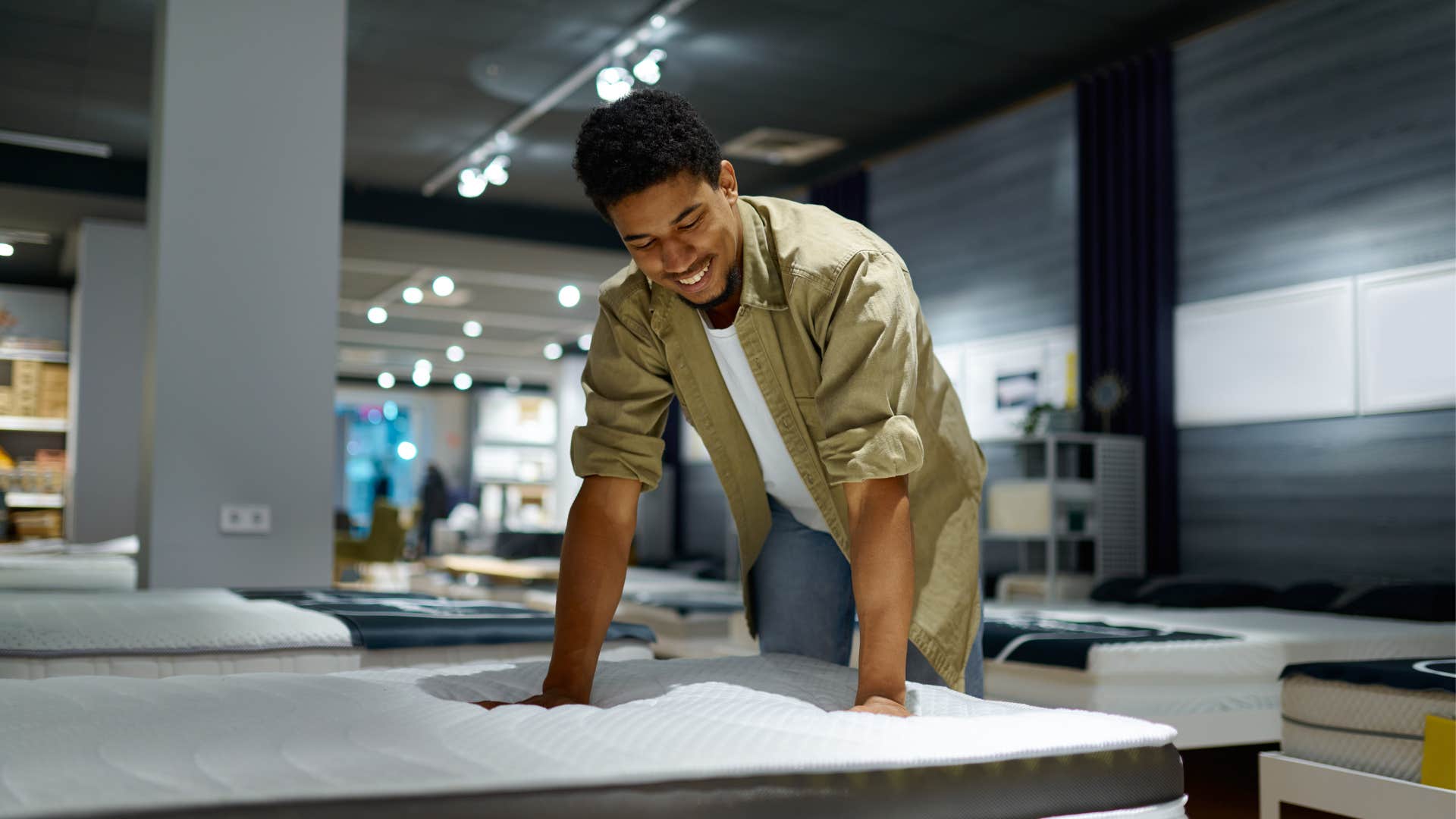 frugal man shopping for a new mattress