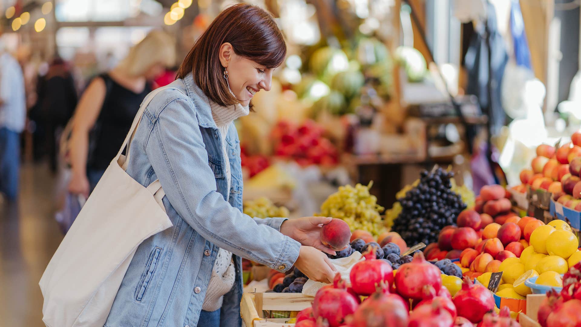 woman looking at fruits at the grocery store