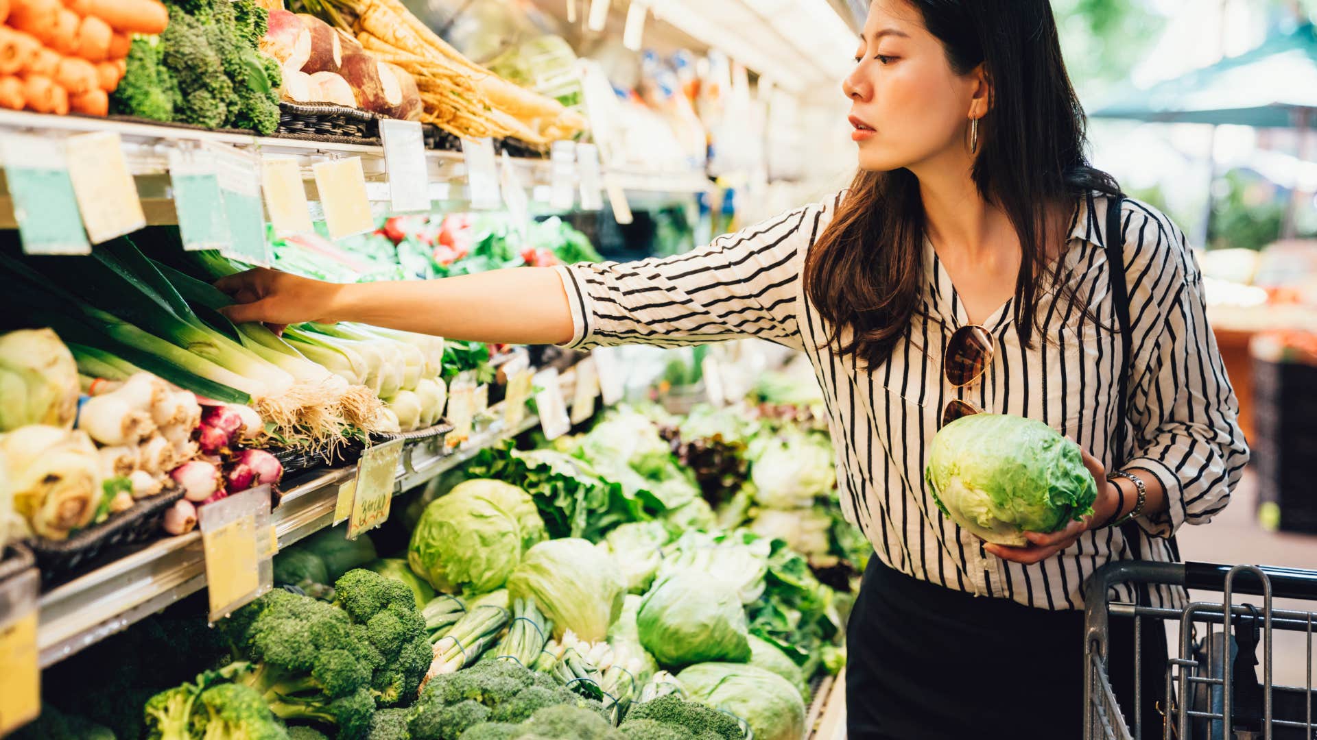 woman looking at produce that isnt on sale