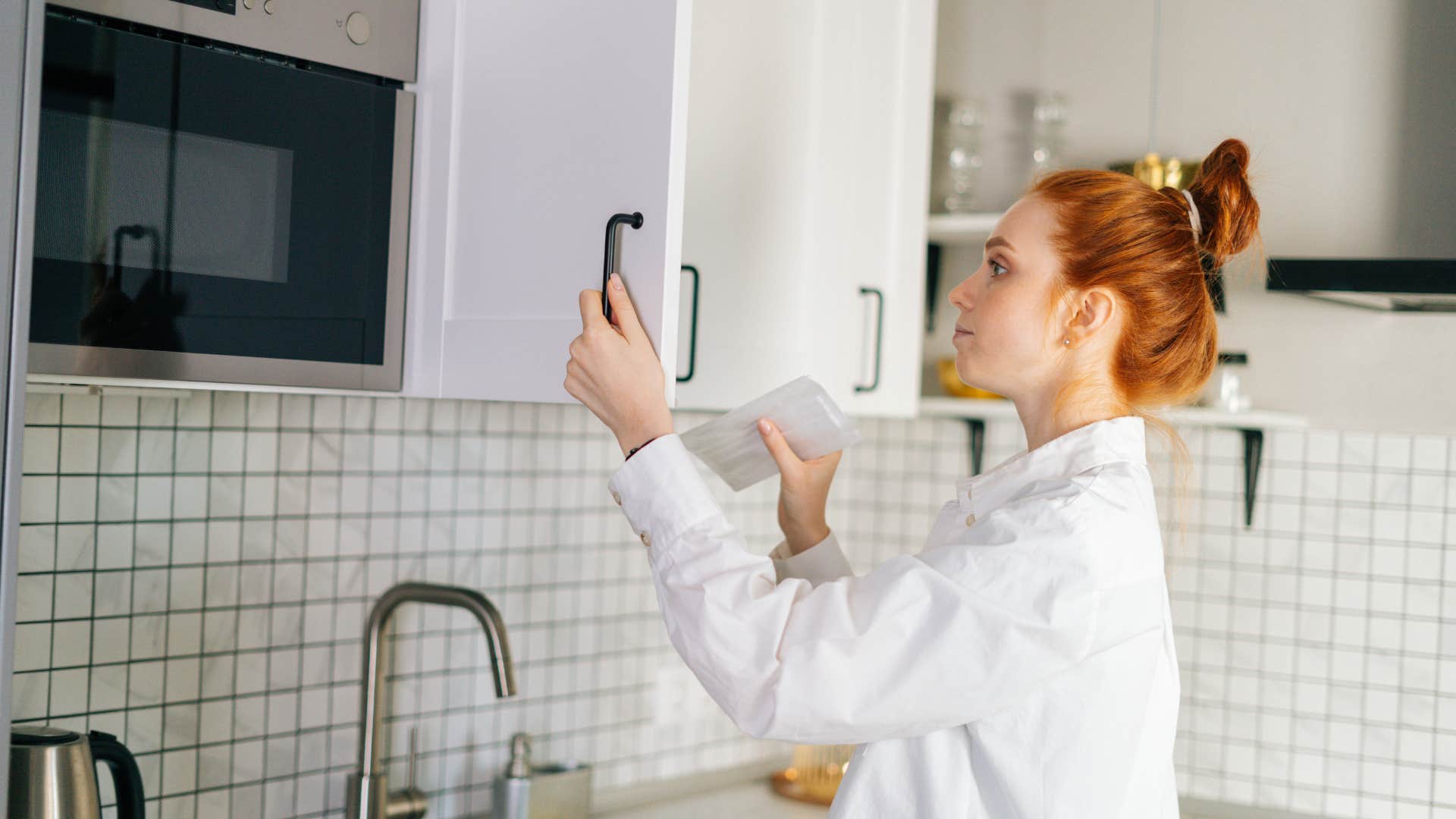 woman checking her pantry before grocery shopping