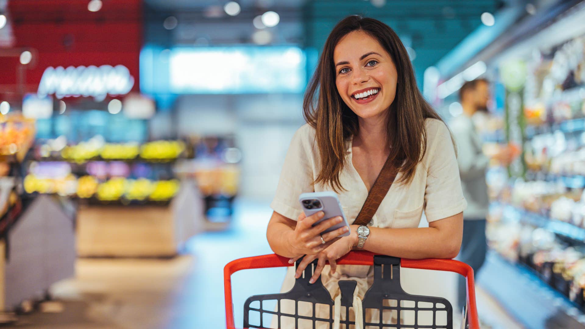 woman shopping in white shirt and smiling as she makes constant impulse purchases