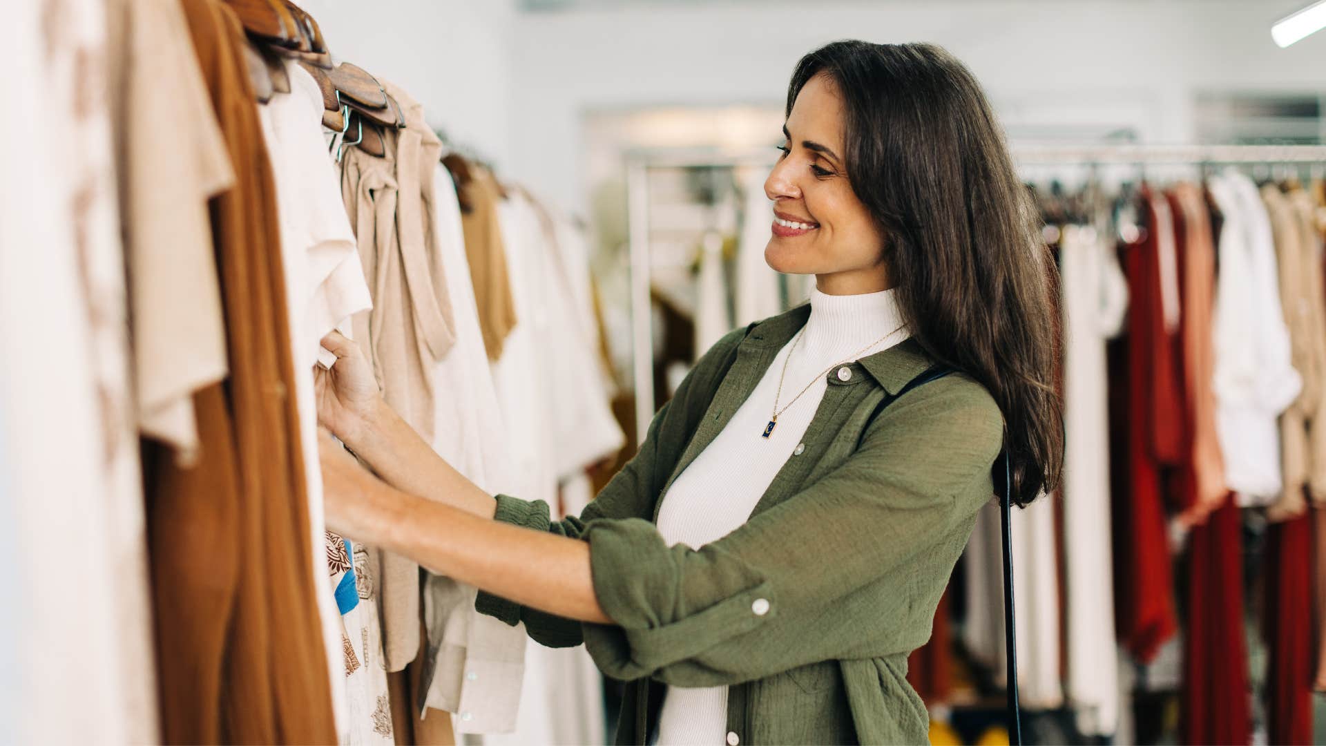 woman in green jacket obsessed with brands as she surfs through clothes