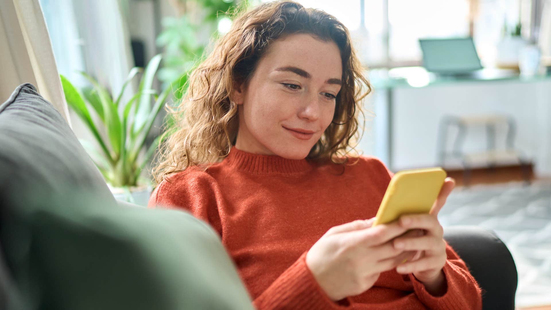 woman who knows that going no contact can be healthy looking at her phone